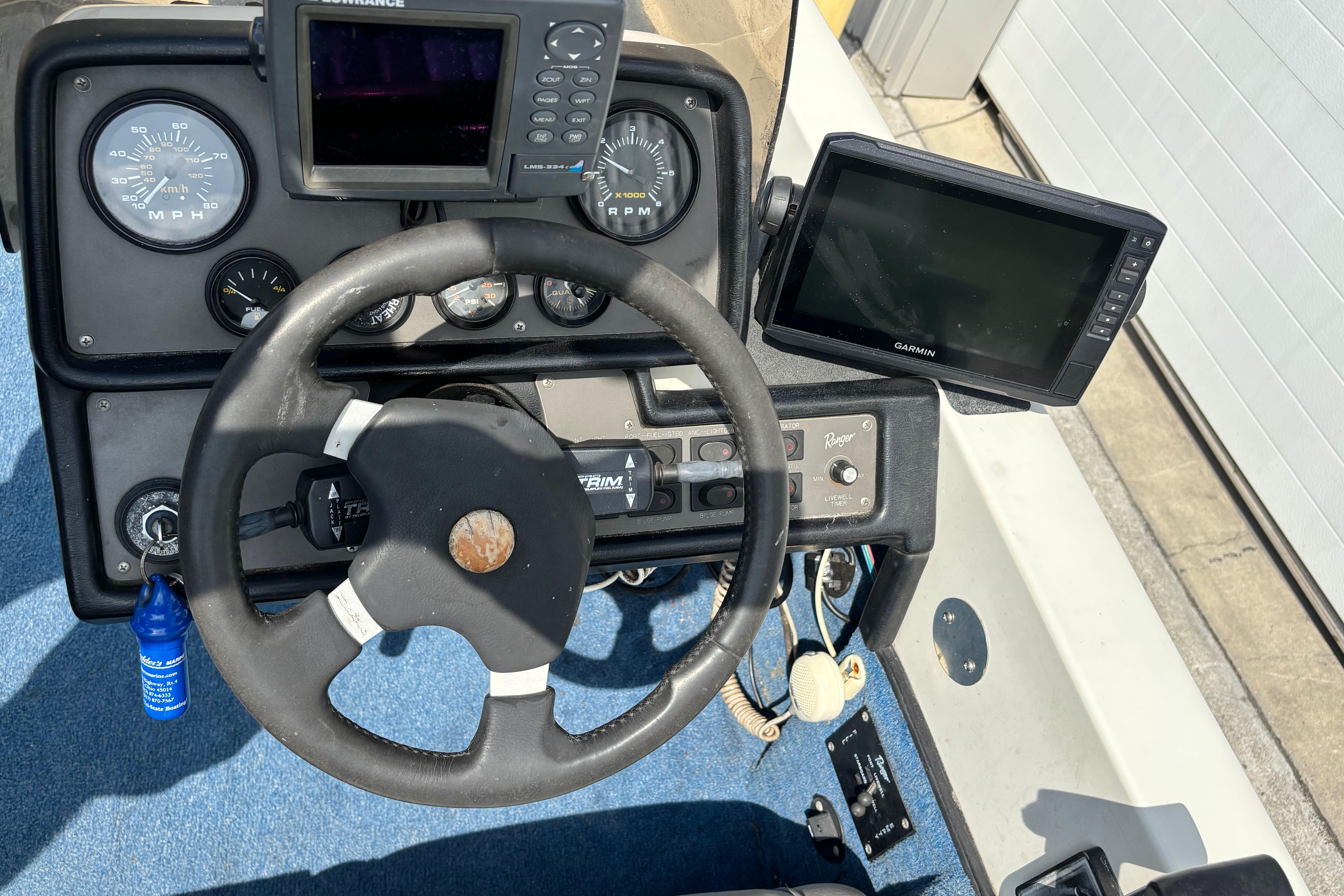 1991 Ranger 461VS boat dashboard with steering wheel, gauges, and Garmin navigation system.