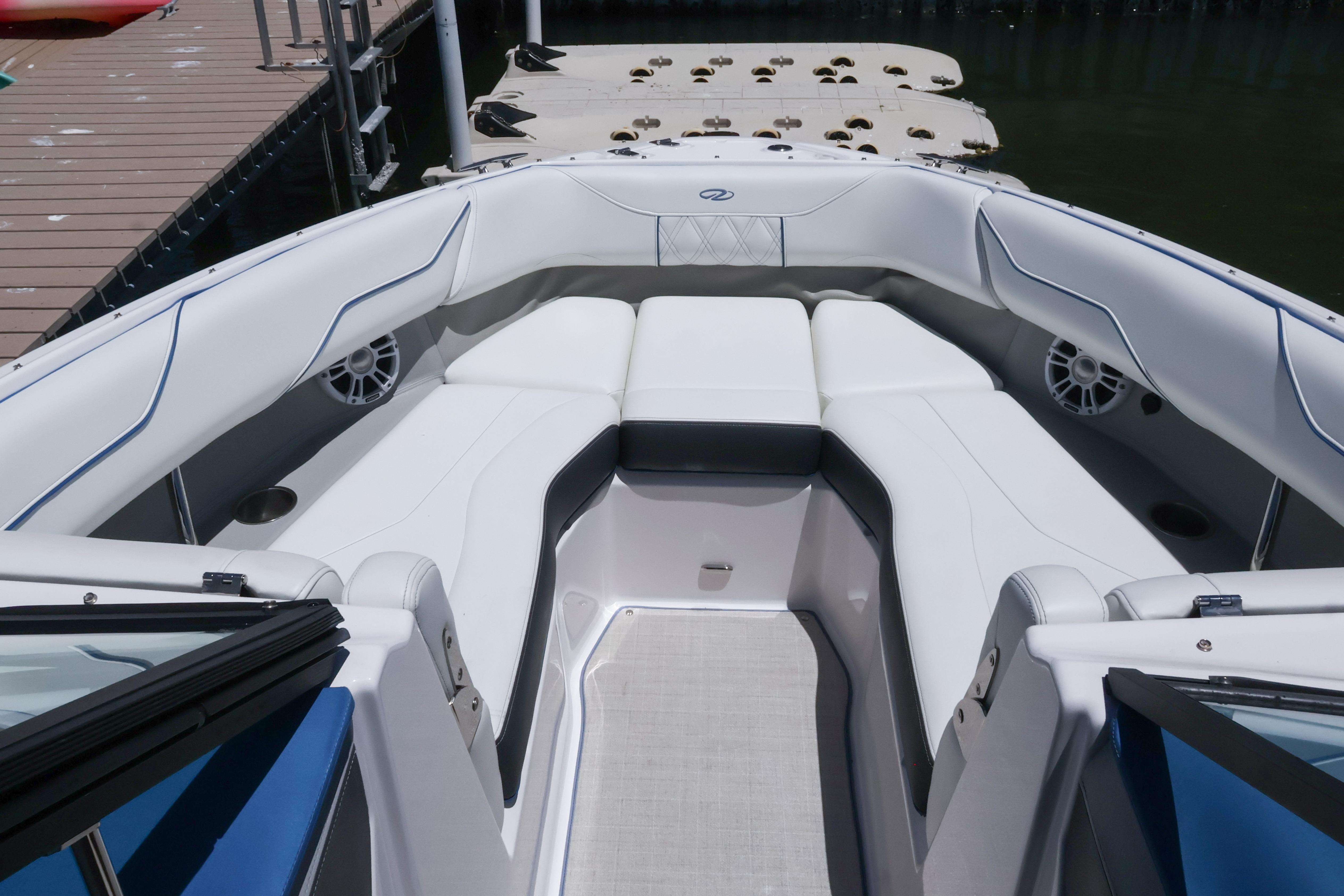 2020 Regal LX4 boat interior with white seating and modern design at a dock.