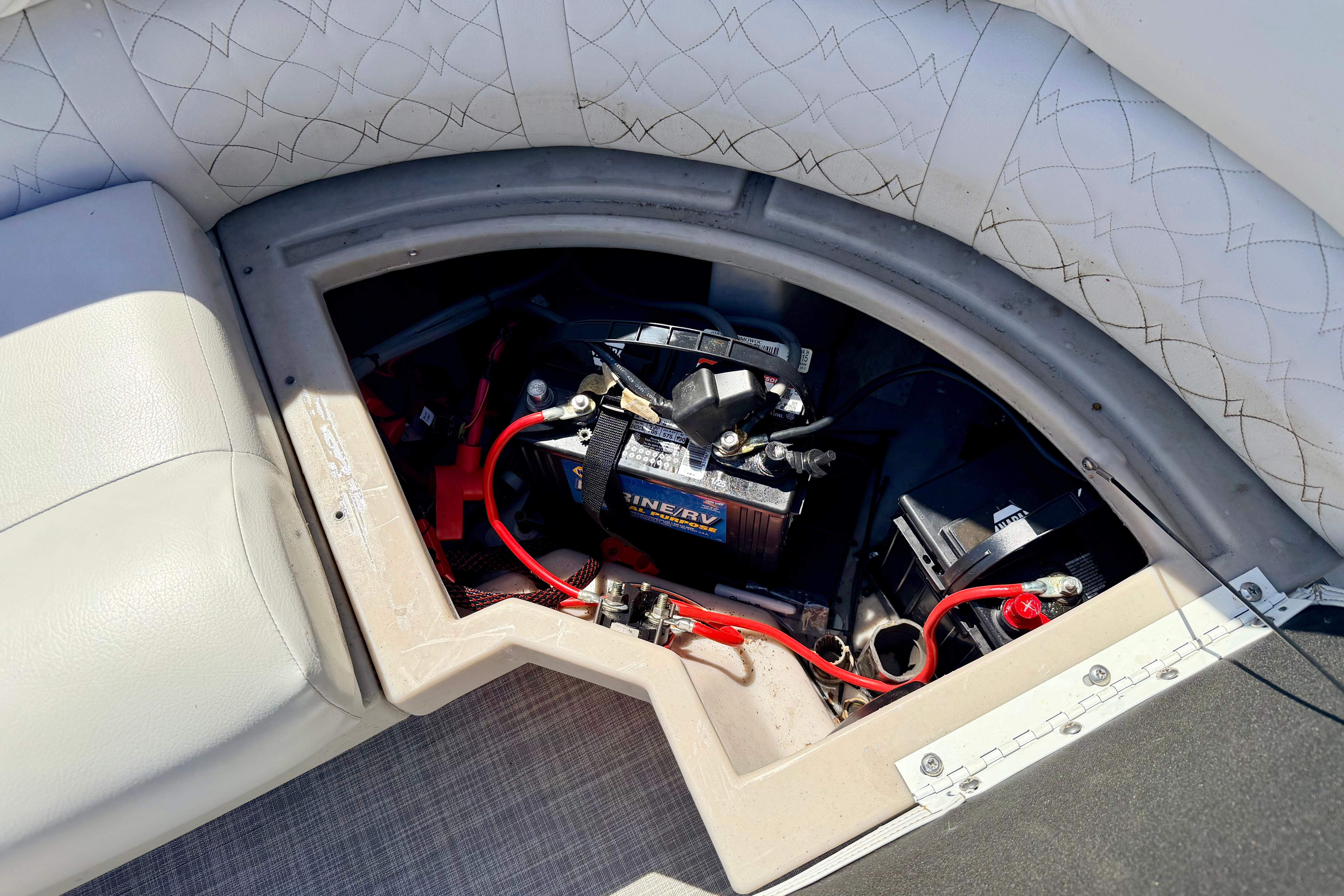 Battery compartment of 2019 Crestliner 240 Rally DX CW boat, featuring marine battery and wiring.