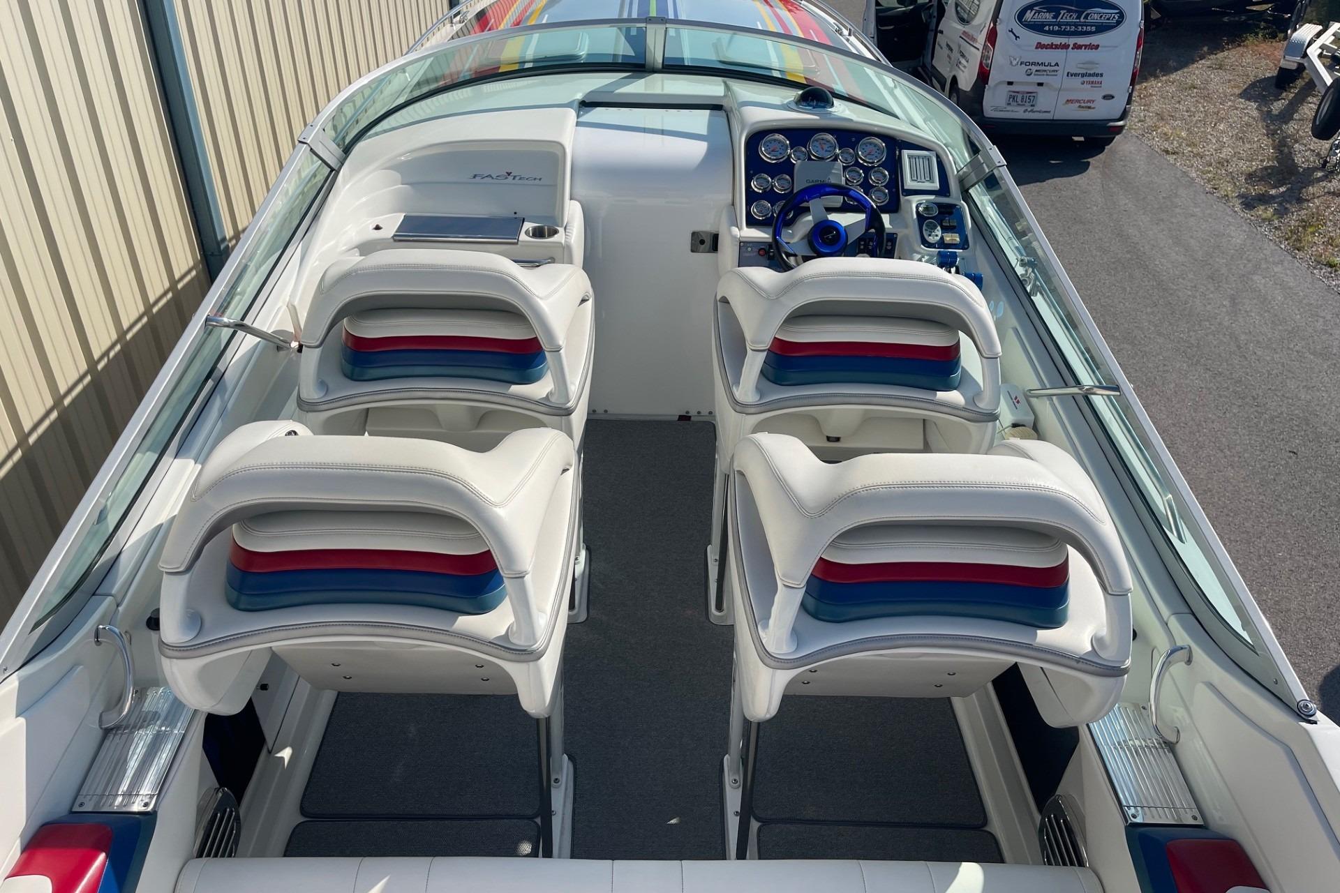 2004 Formula 382 FASTech boat interior with white seating and colorful accents.