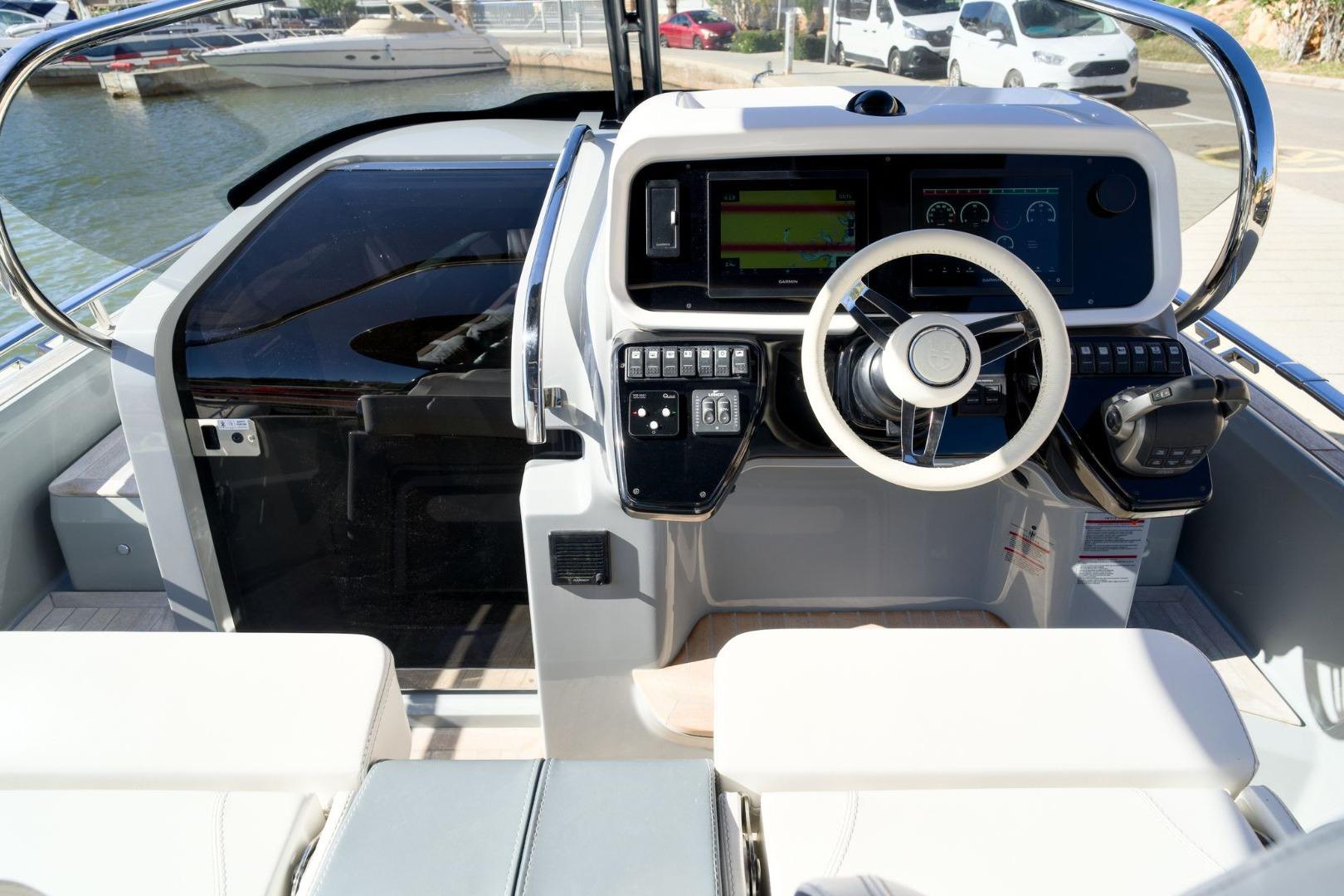 2023 Invictus GT320 boat cockpit with modern steering and control panel.