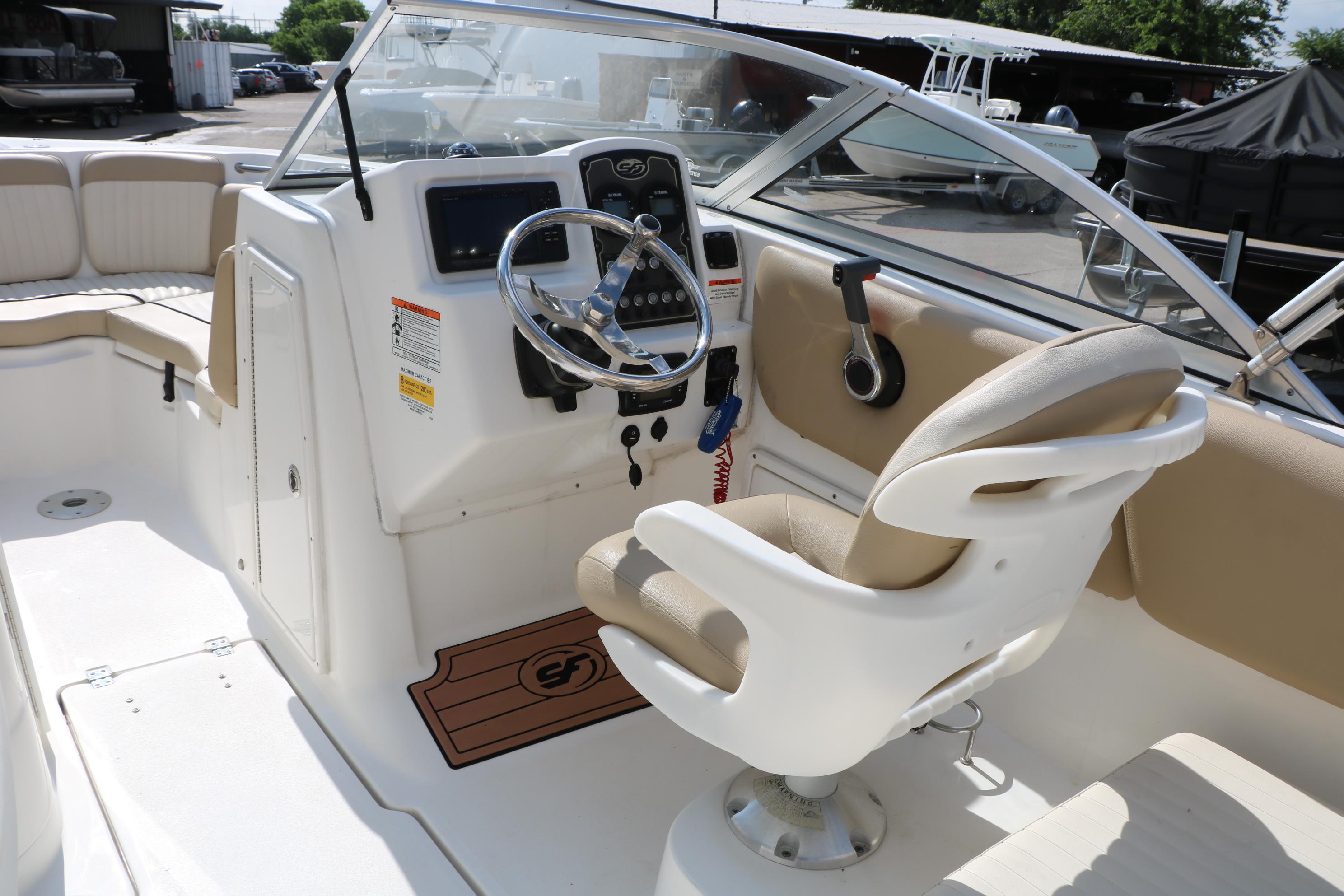 2017 Sea Fox 226 Traveler boat interior with steering wheel and captain's chair.