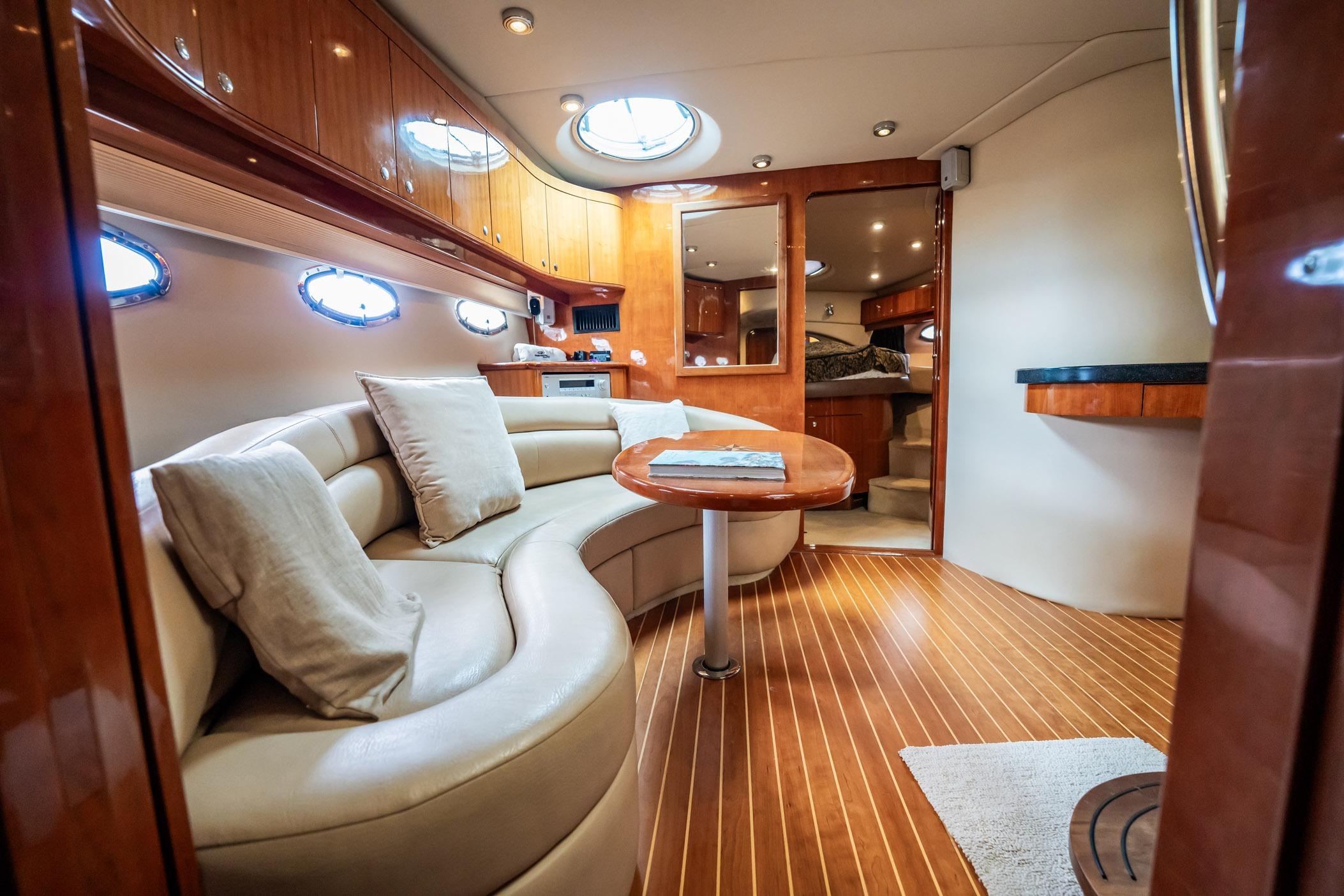 Luxurious interior of 2008 Regal Commodore 4460 yacht with elegant seating and wooden finishes.