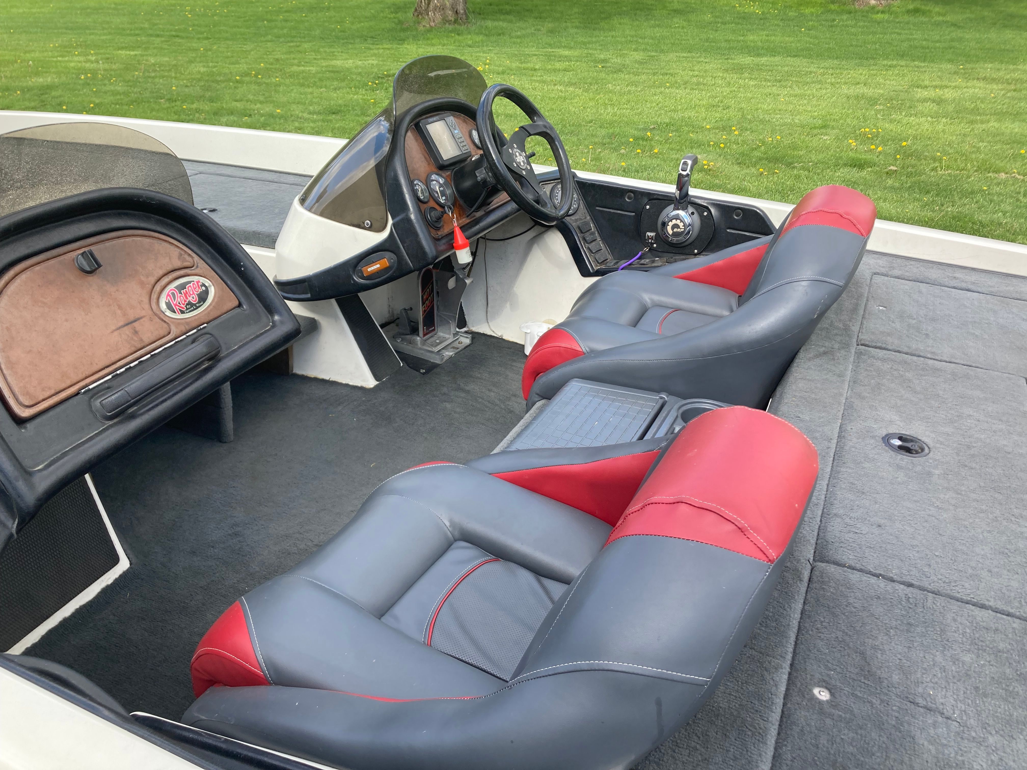 The image shows the cockpit of a 2002 Ranger 522DVX Comanche with gray and red seats.