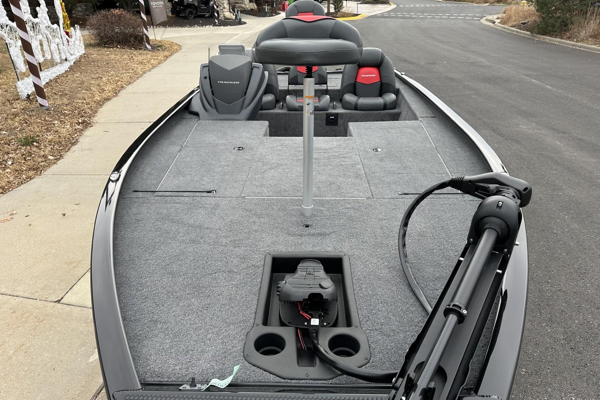 2025 Tracker Savage 215 boat with spacious deck and seating, parked on a street.