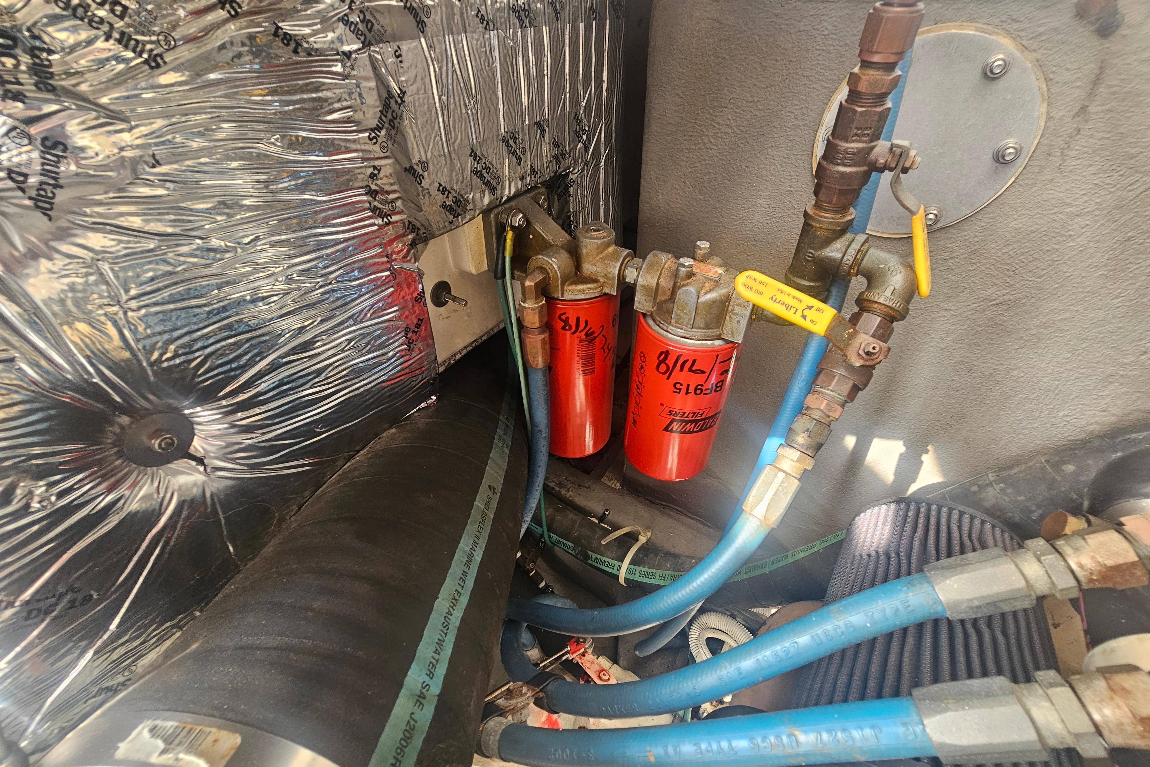 Engine compartment of 2003 Topaz 32 Express with fuel filters and insulated wiring.