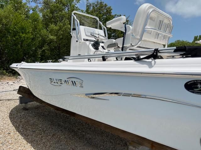 2021 Blue Wave 2200 PureBay boat on gravel, side view.