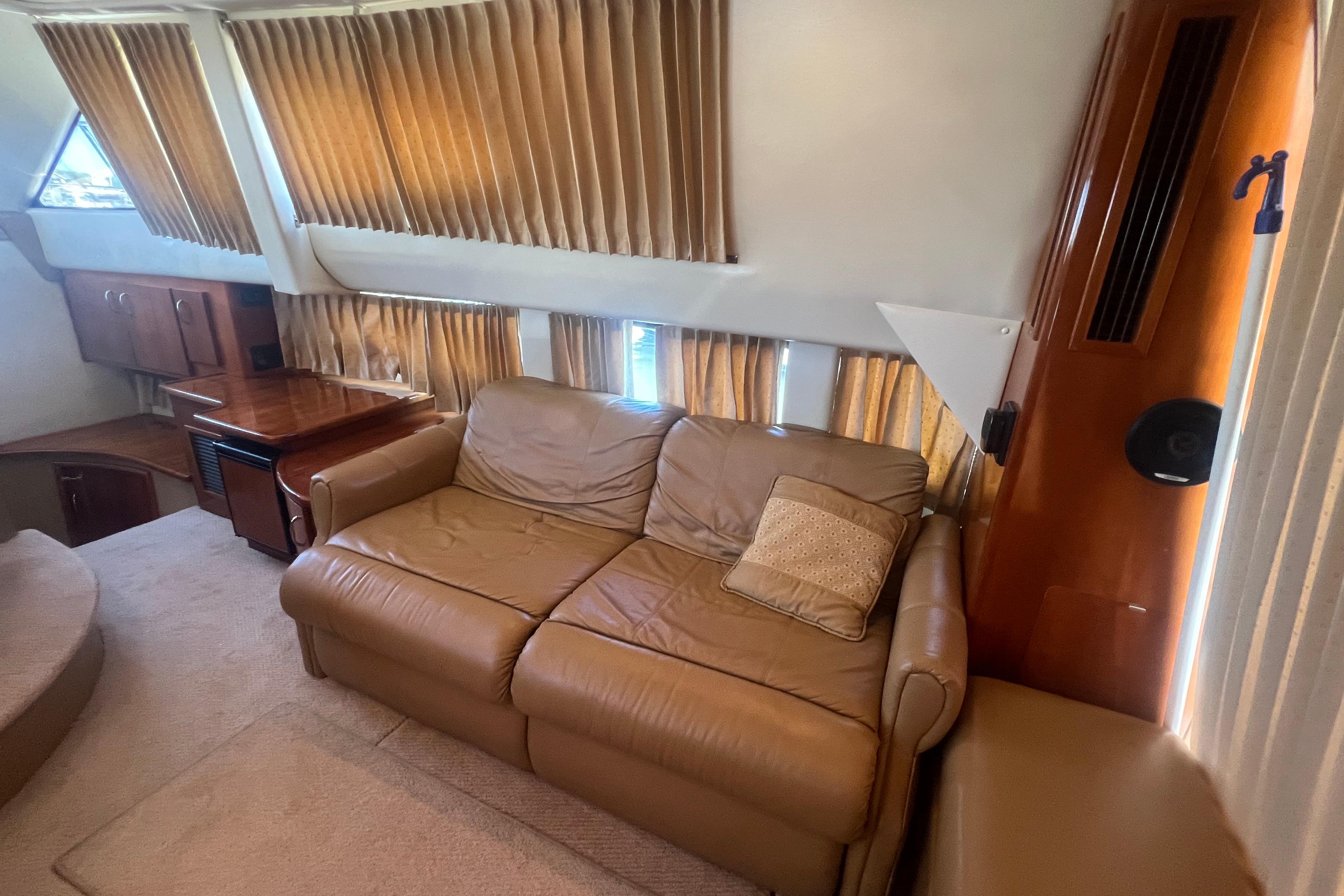 Interior of 2004 Carver 360 Sport Sedan with leather sofa and wooden accents.