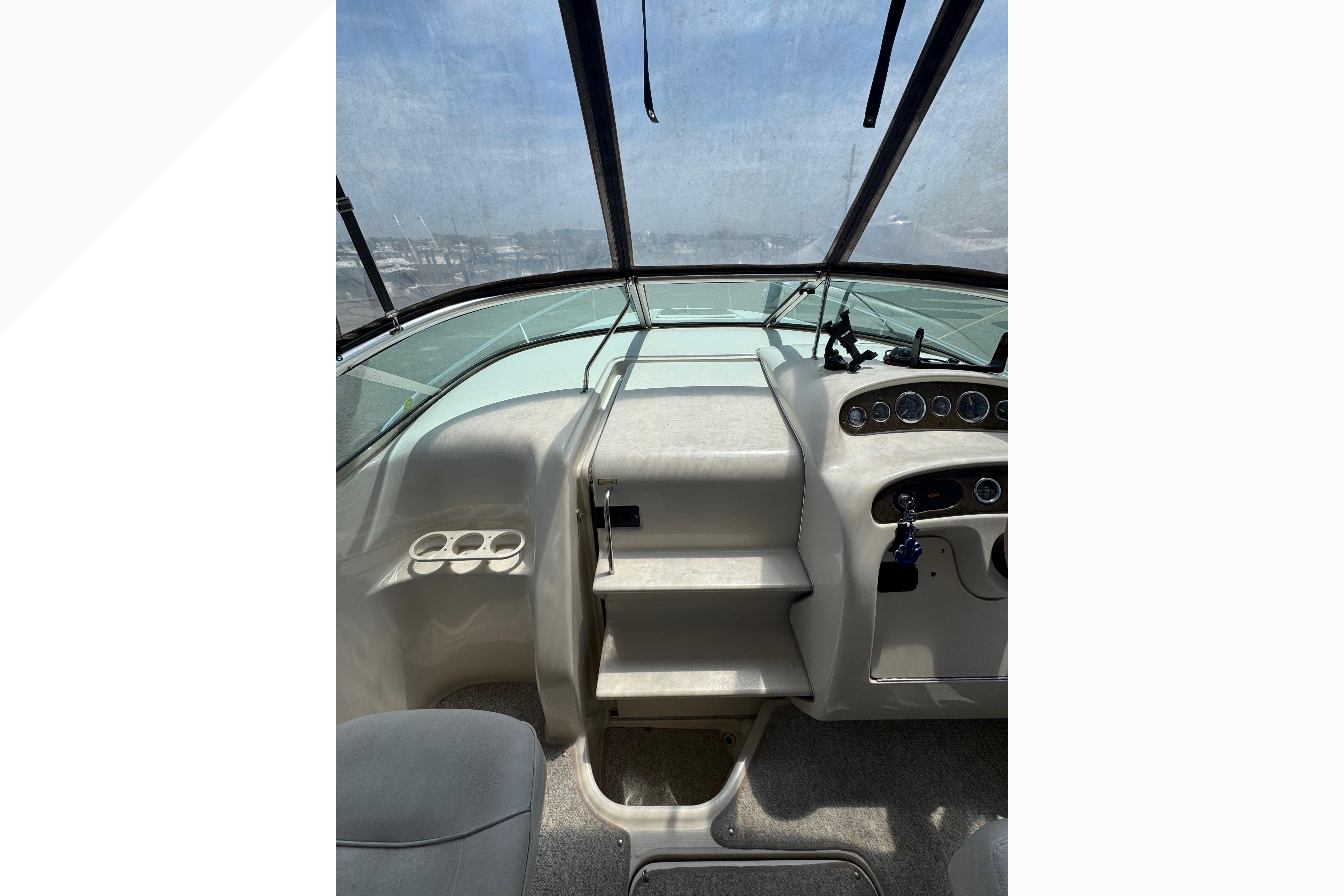 Interior view of 2001 Sea Ray 245 Weekender boat cockpit with steering controls.
