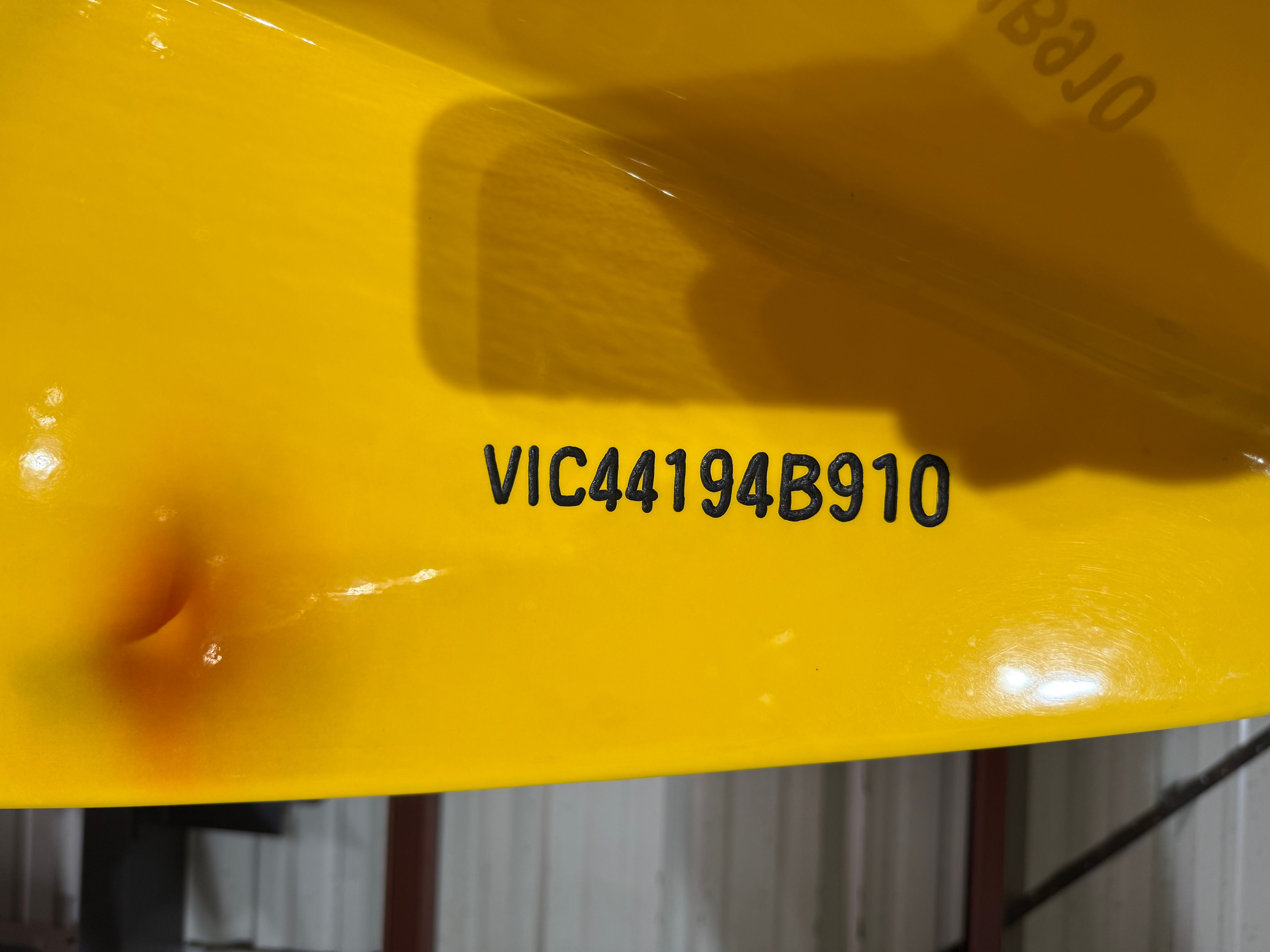 Close-up of a yellow boat hull number on a 2010 MTI CAT.