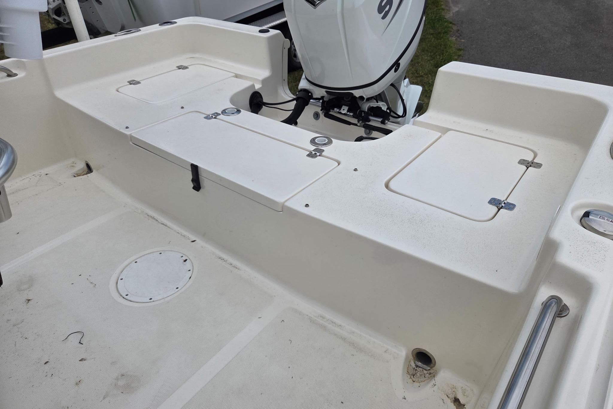 2023 Bulls Bay 2200 boat deck with storage compartments and outboard motor.