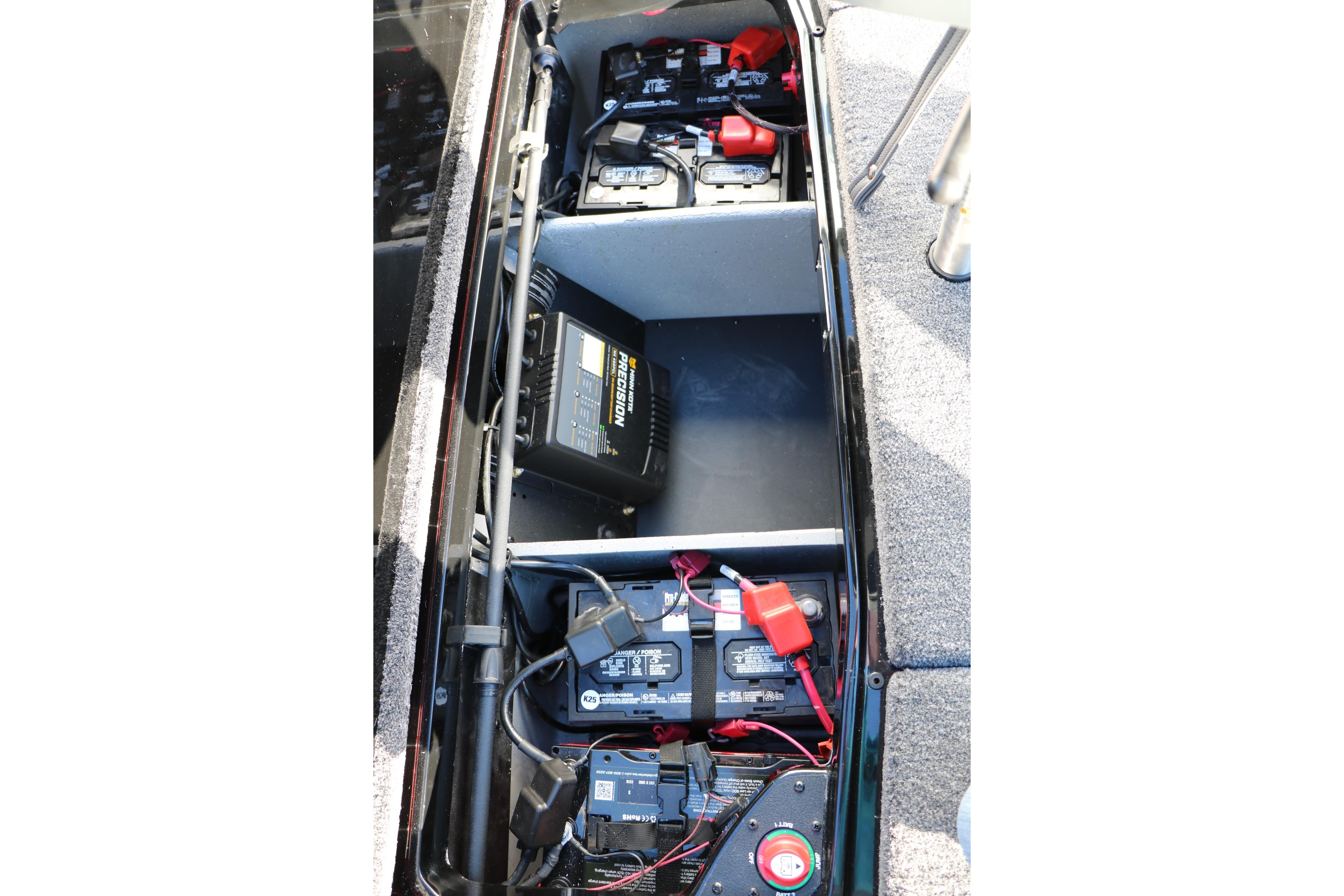 2026 Vexus VXs21 boat battery compartment with multiple batteries and wiring.