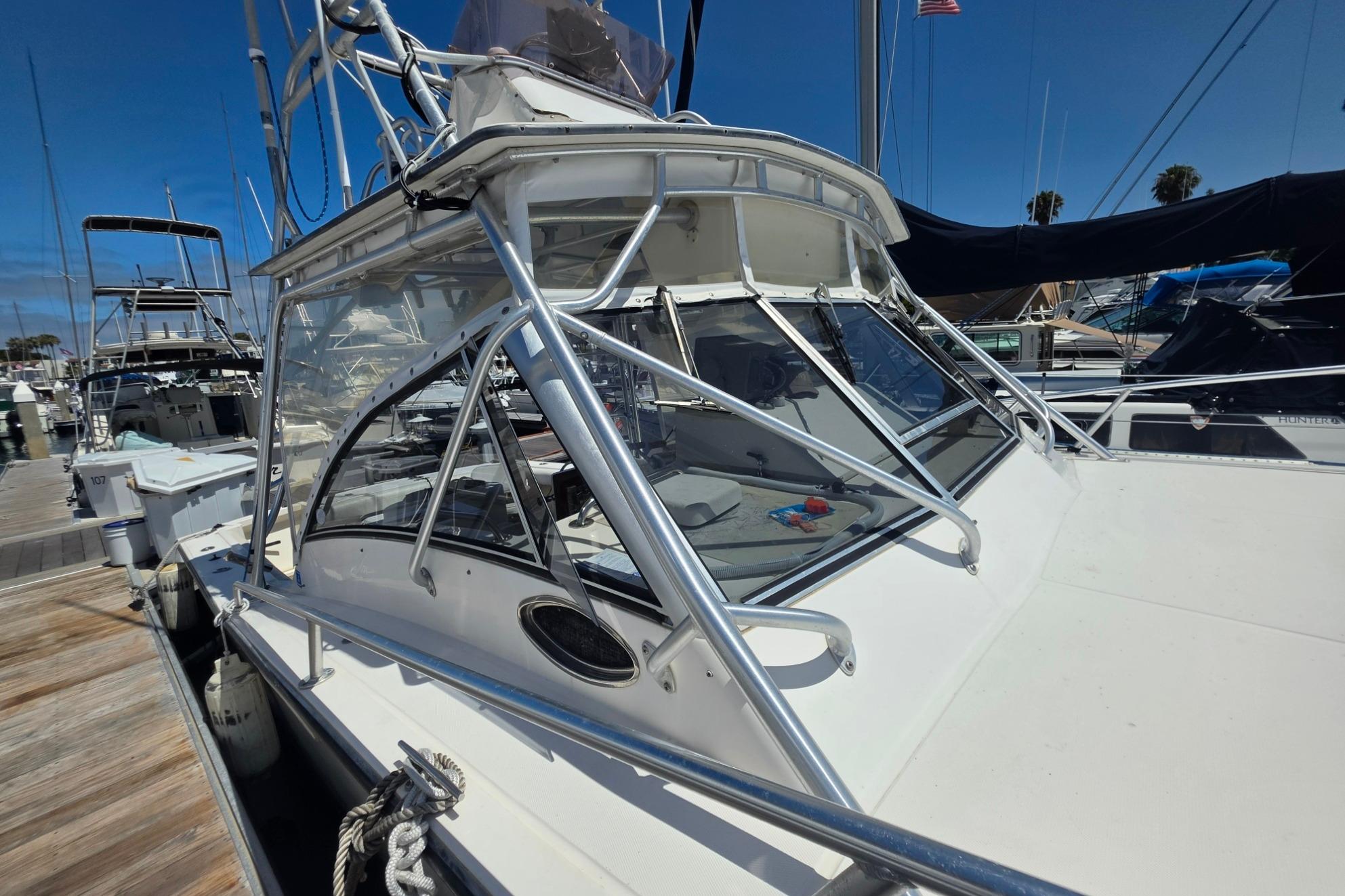 1999 Albemarle 305 Express Fisherman boat docked at marina, showcasing sleek design and sturdy build.