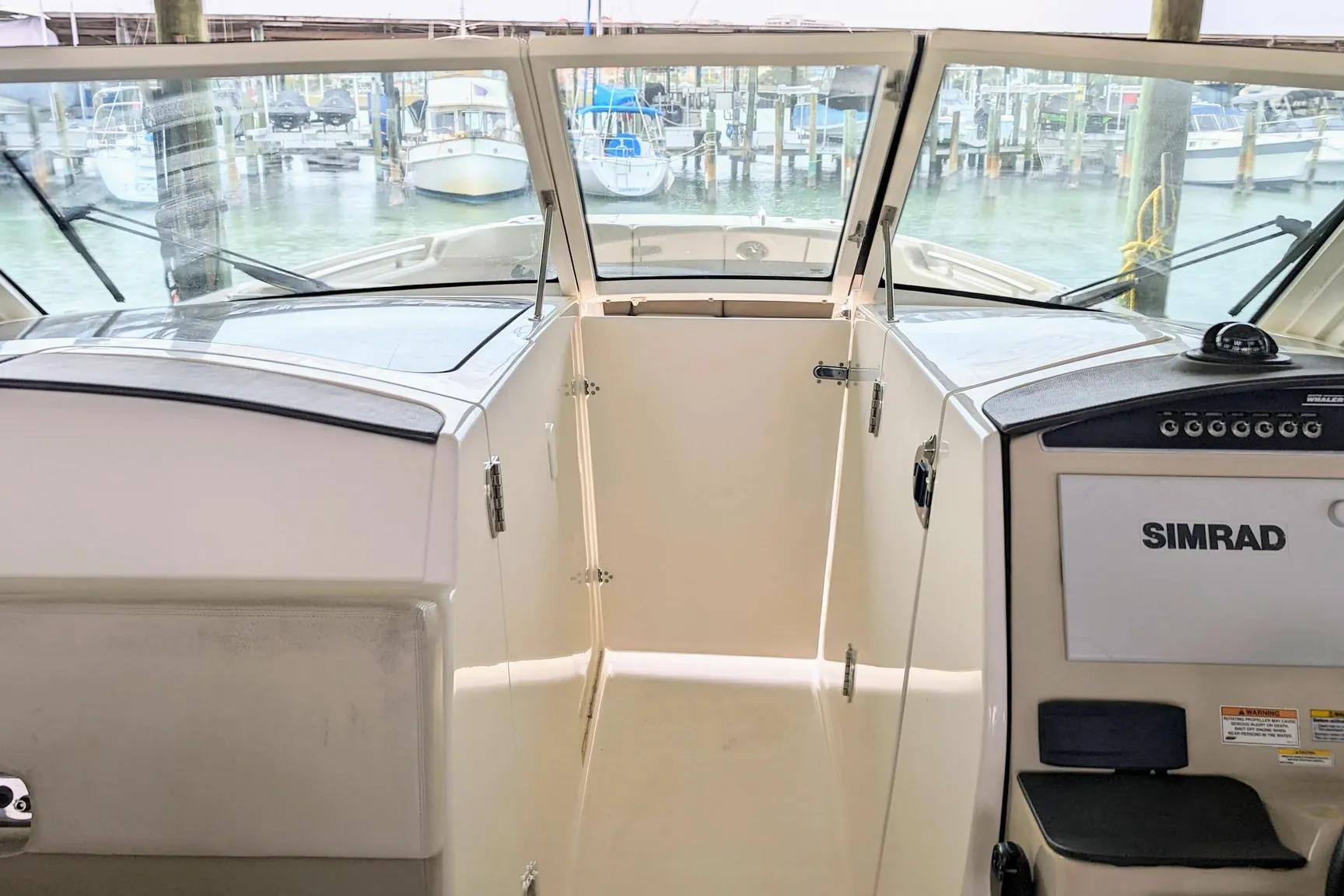 2017 Boston Whaler 320 Vantage boat interior with Simrad navigation system at marina.