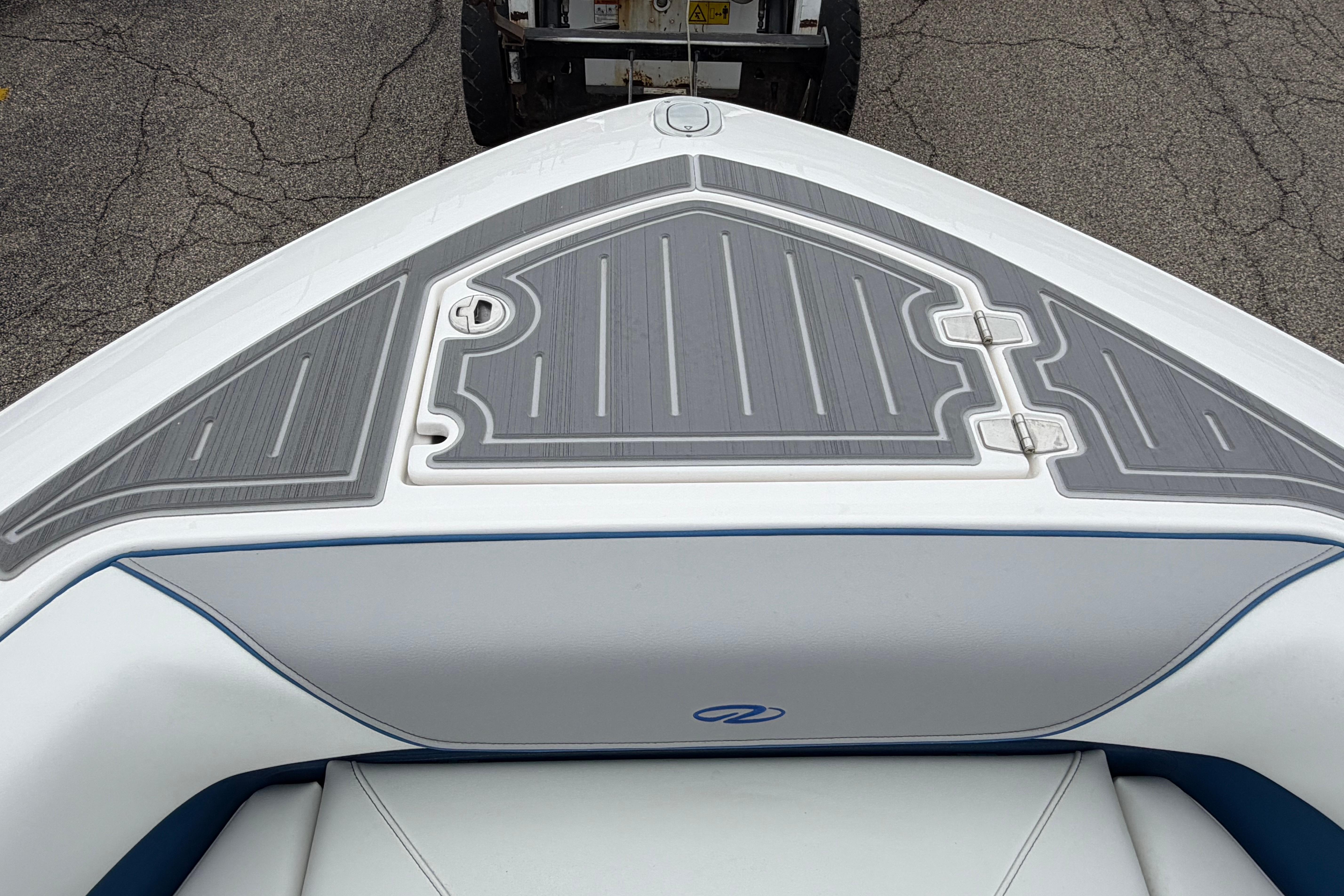 2026 Regal LS9 Surf boat bow with sleek gray decking and white upholstery.