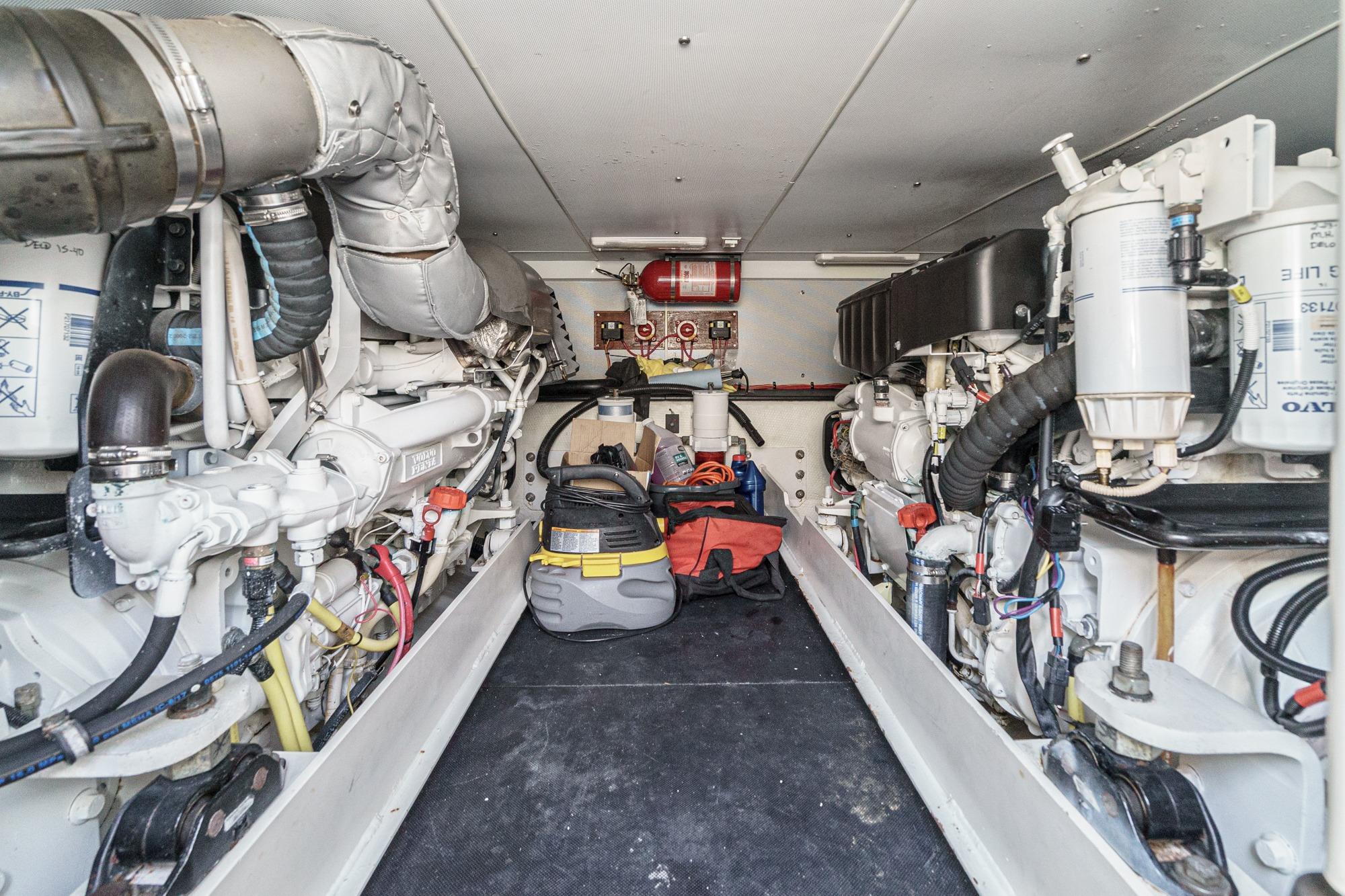 Engine room of a 2007 Silverton Convertible yacht, showcasing dual engines and equipment.