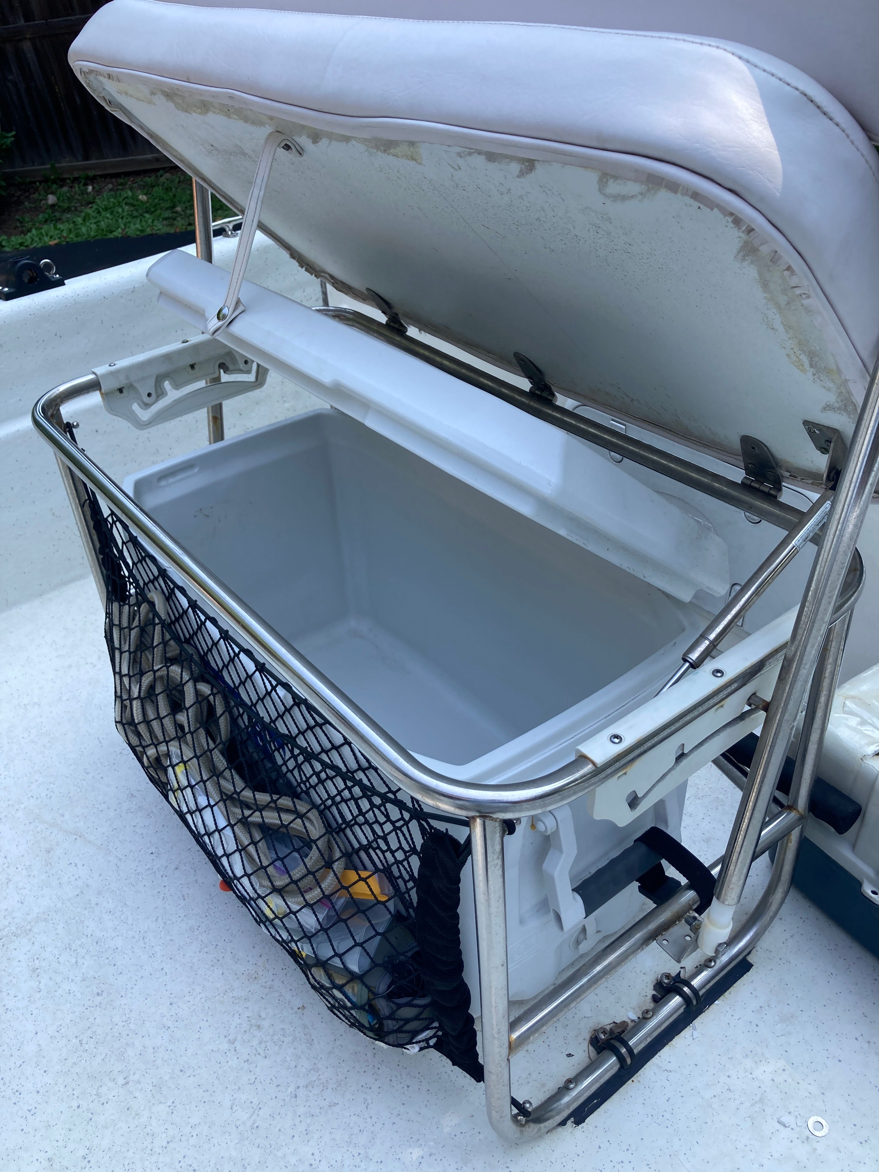 An open storage compartment with netting on a Carolina Skiff JVX16CC boat.