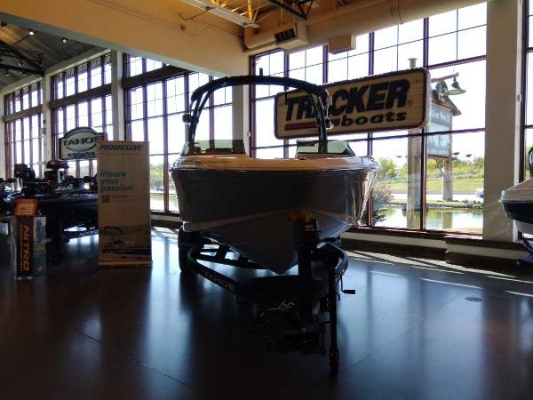 2023 Tahoe 210 Si Limited boat on display in showroom with large windows.
