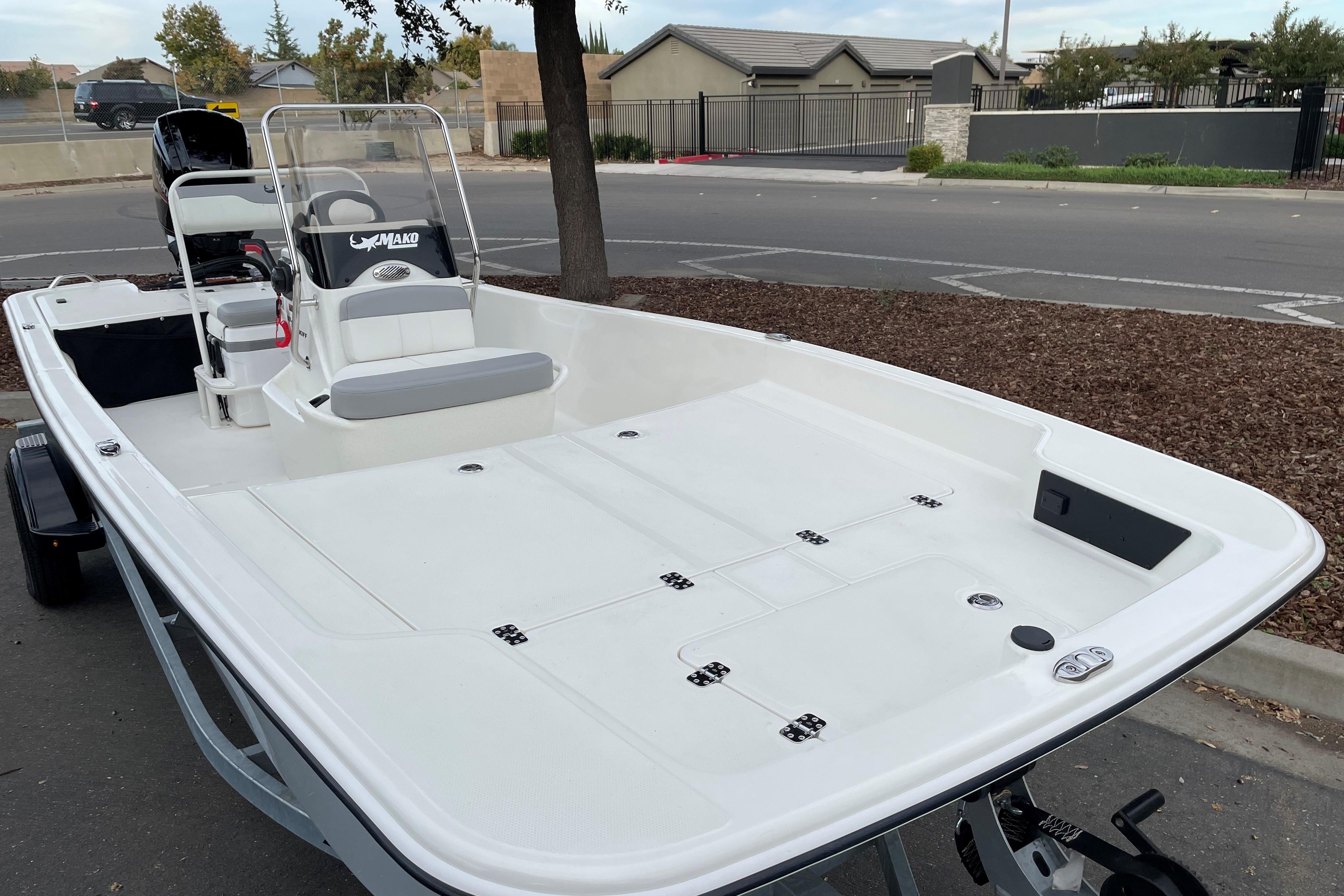 2025 Mako Pro Skiff 17 CC boat parked on a street, showcasing spacious deck design.