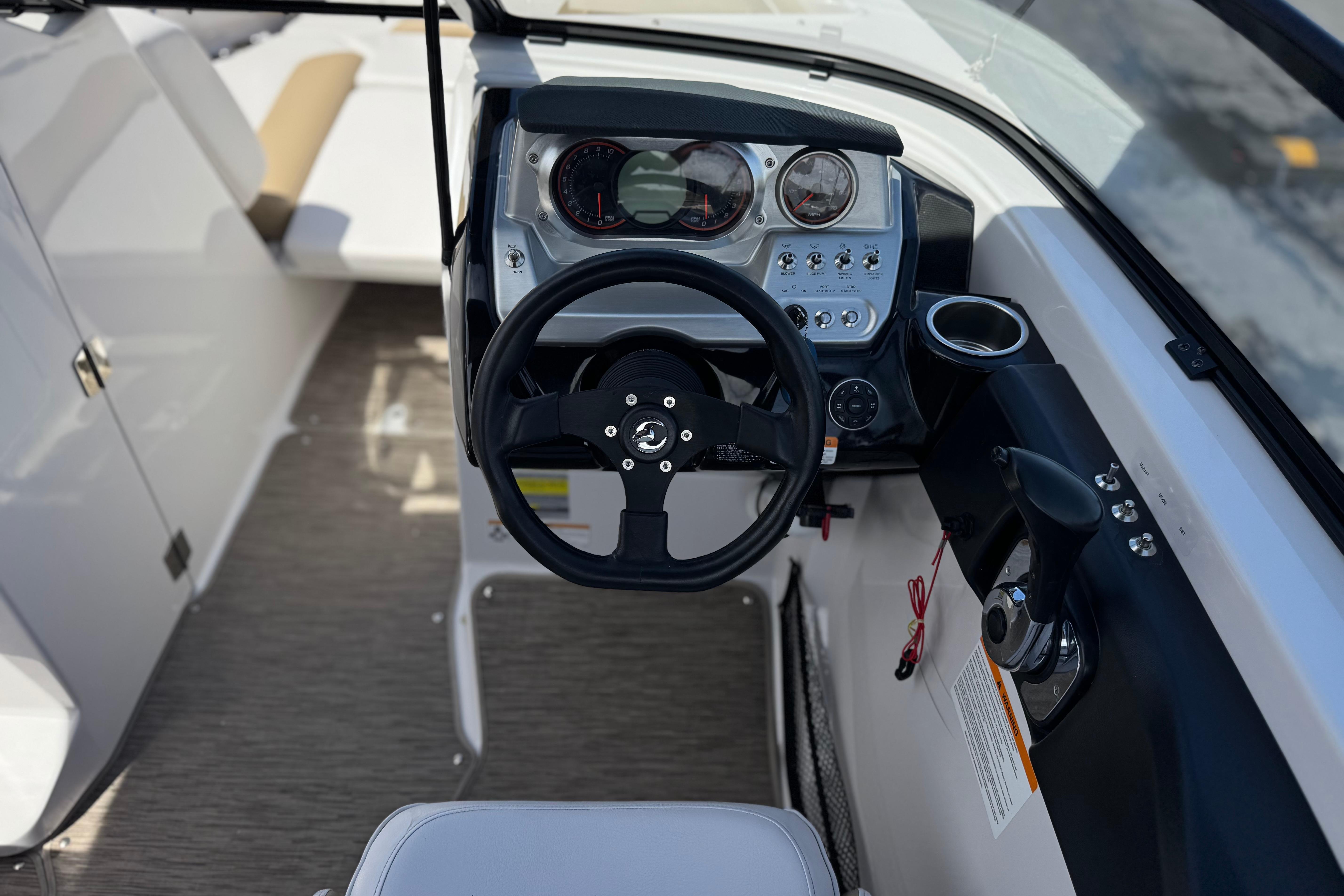 2017 Scarab 255 H.O. Platinum boat cockpit with steering wheel and control panel.