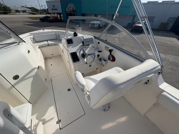 2020 Cobia 220 Dual Console boat interior with steering wheel and seating.
