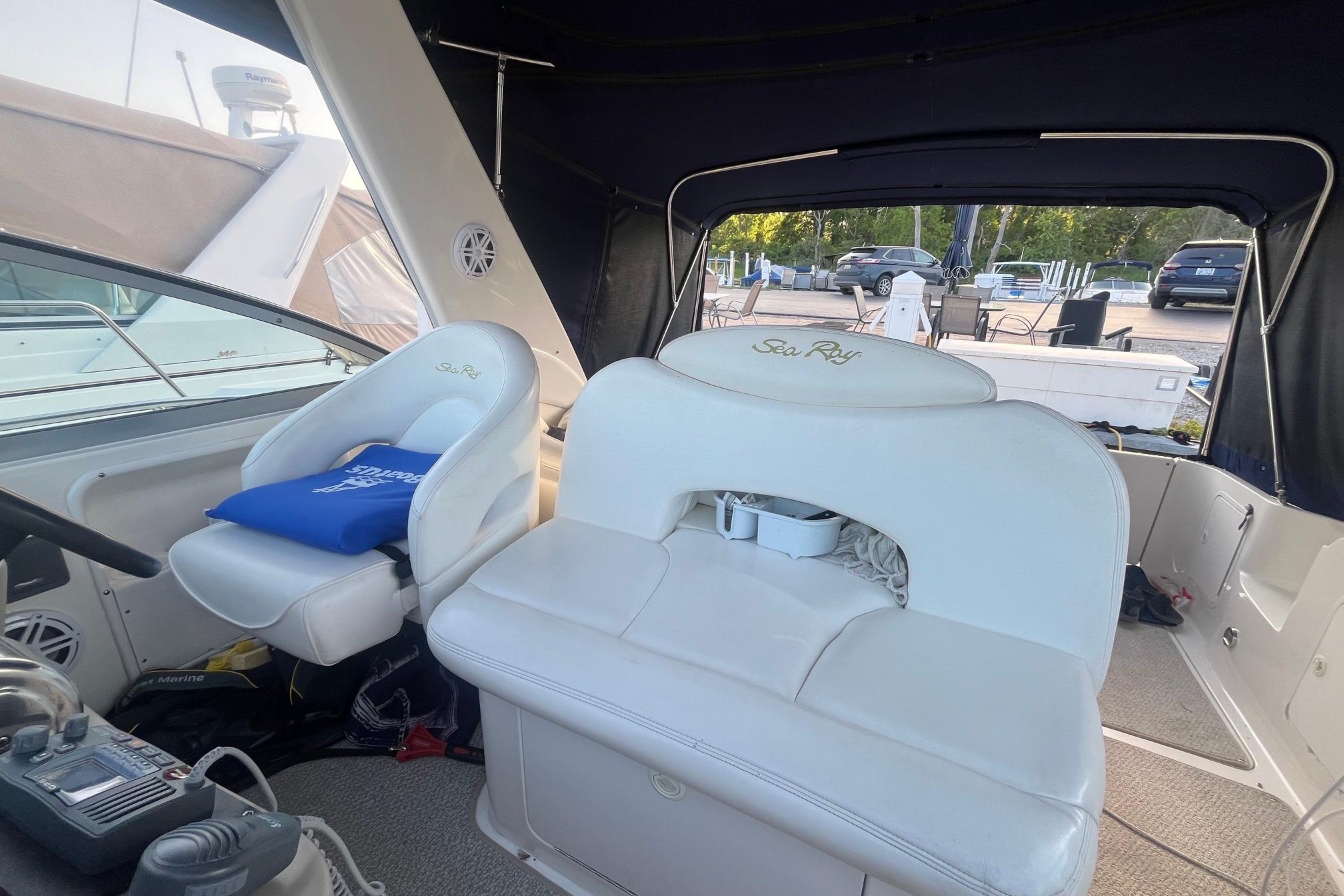 2001 Sea Ray 340 Sundancer cockpit with white seating and helm station.