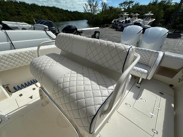 2005 Intrepid 323 boat with quilted seating, docked near a river.