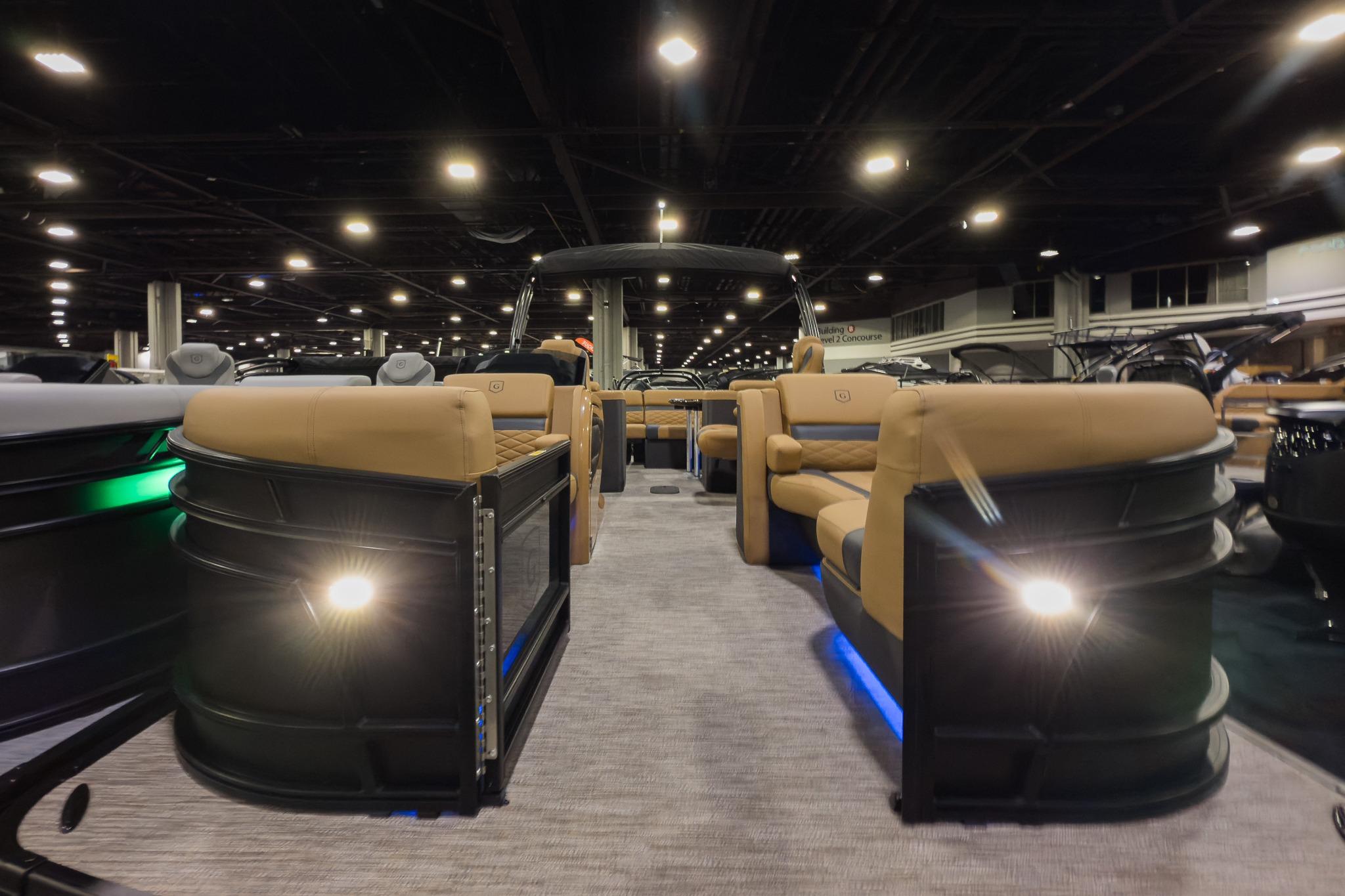 2026 Godfrey Monaco 235 Ultra Lounge pontoon boat interior at a boat show.