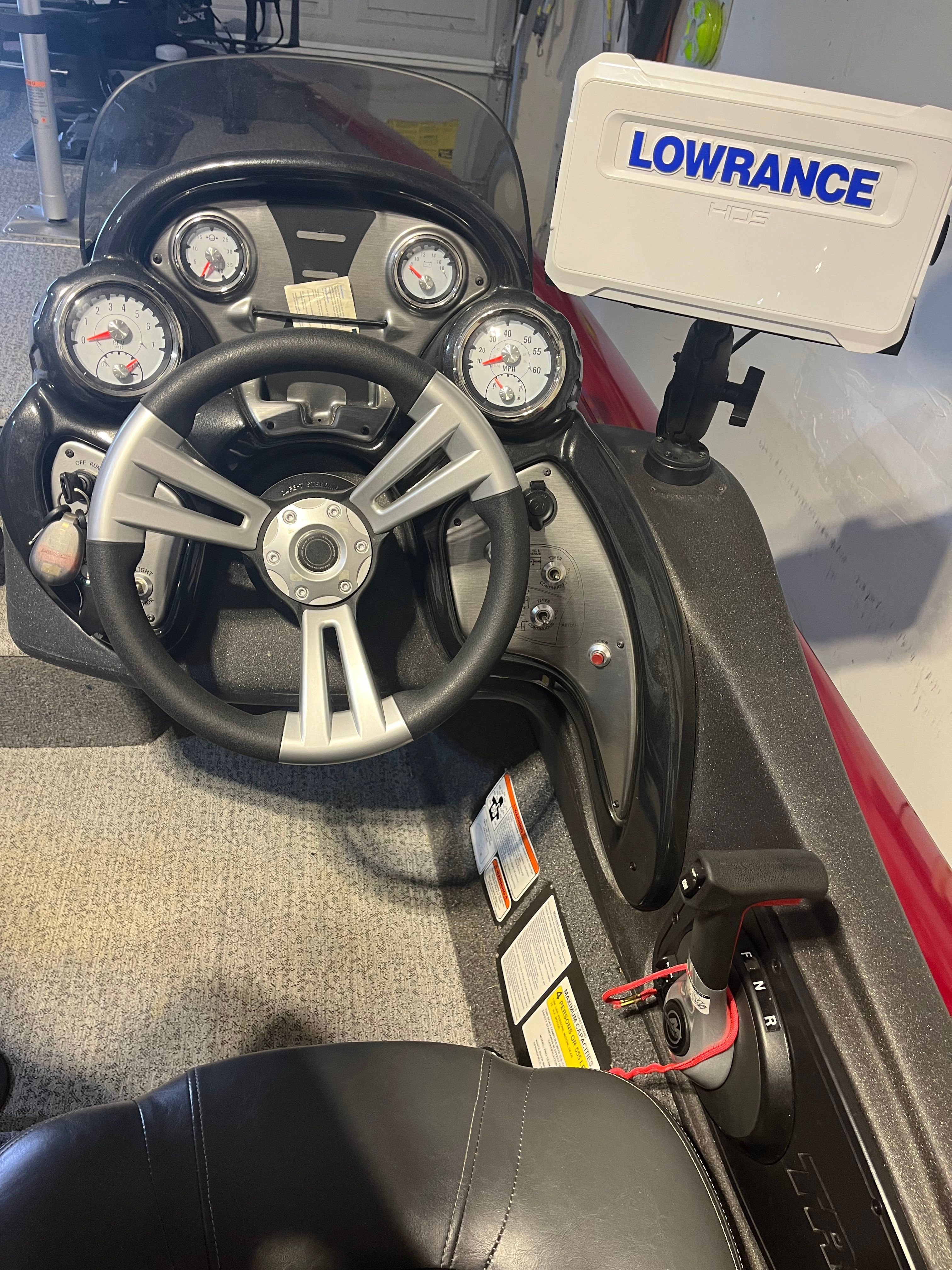 The image shows the cockpit of a 2022 Bass Tracker PRO 175 TEAM TXW TOURNAMENT ED with a Lowrance fish finder.