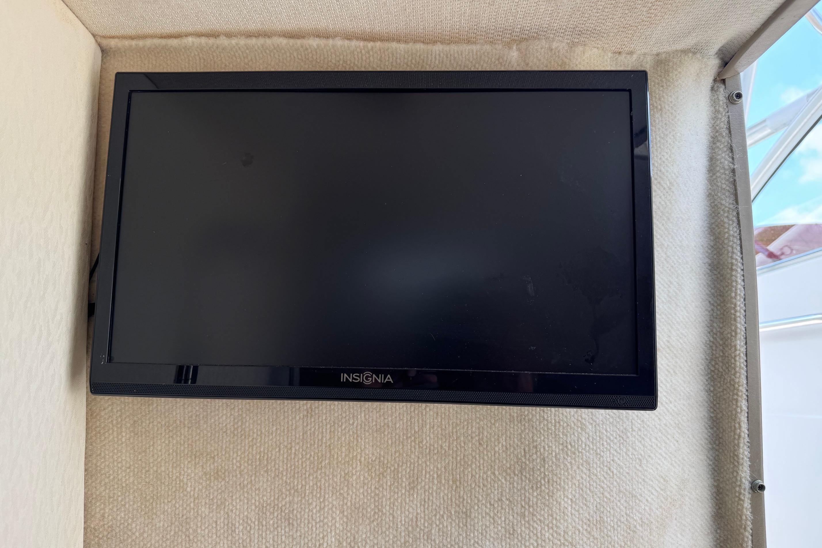 Insignia TV mounted inside a 2000 Maxum 2400 SCR boat cabin.