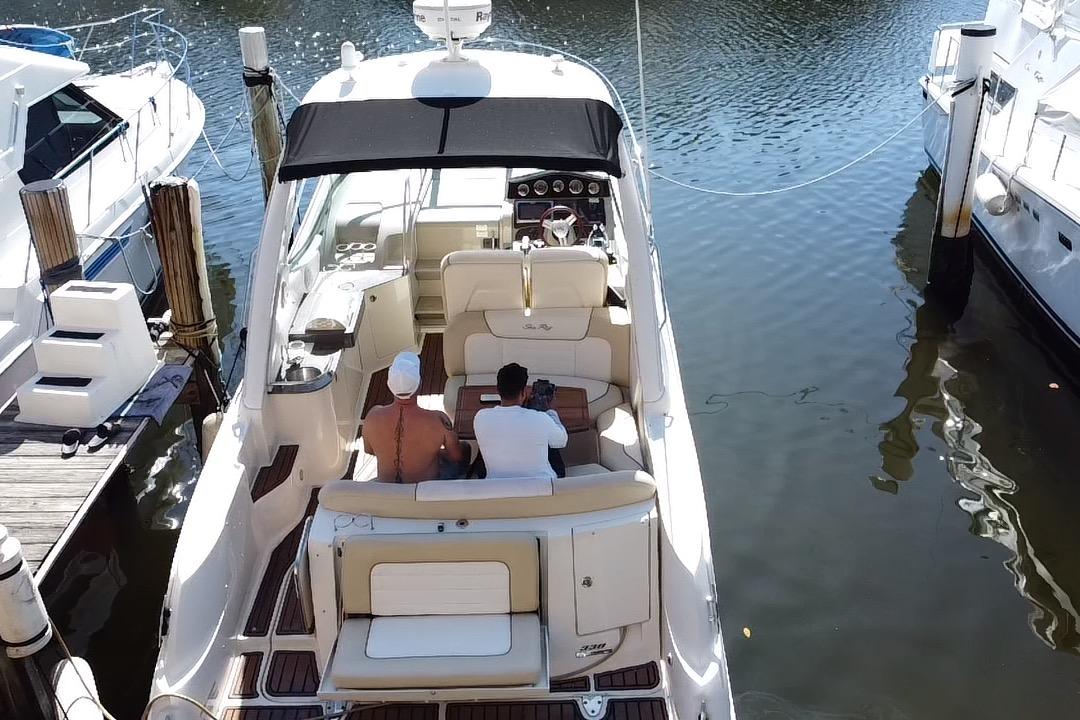 2012 Sea Ray 330 Sundancer docked with passengers enjoying the view.