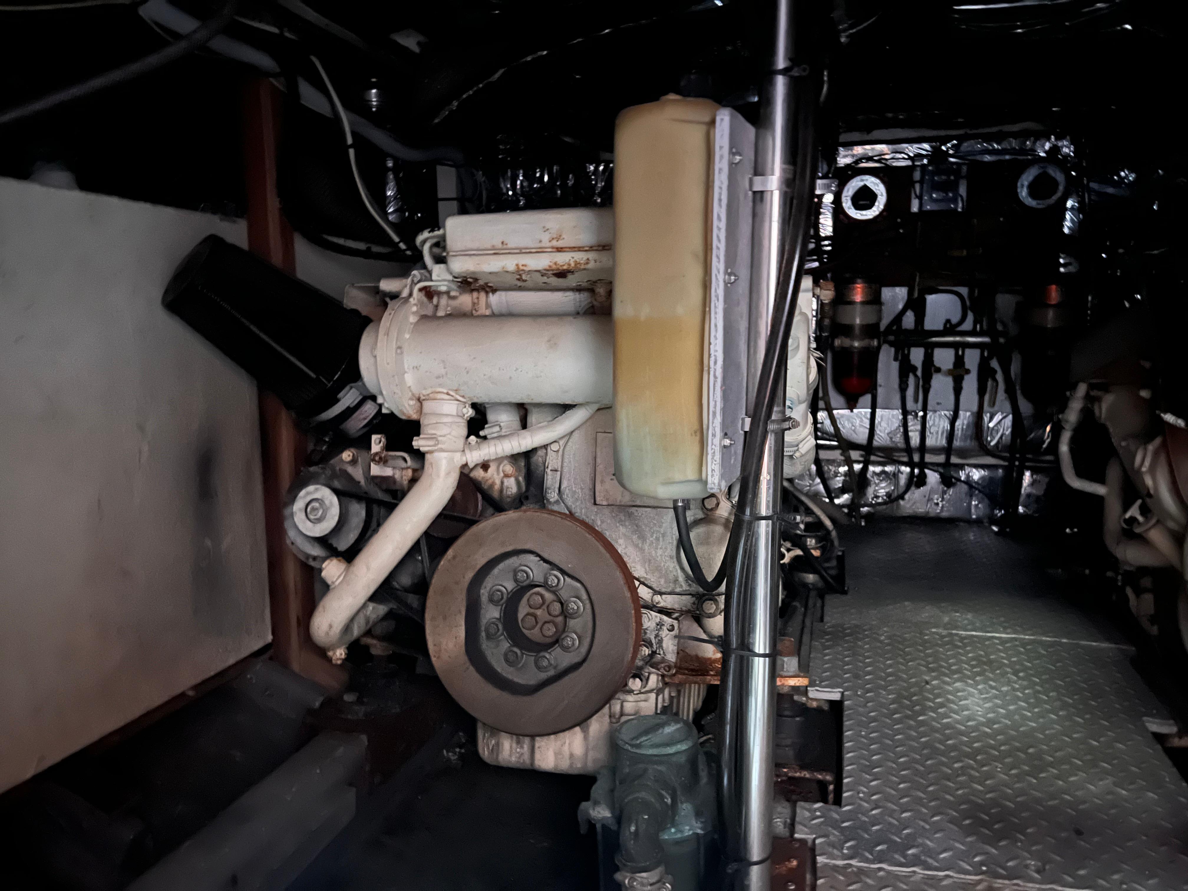Engine room of a 1988 Canyon Bay 40 boat, showcasing mechanical components.