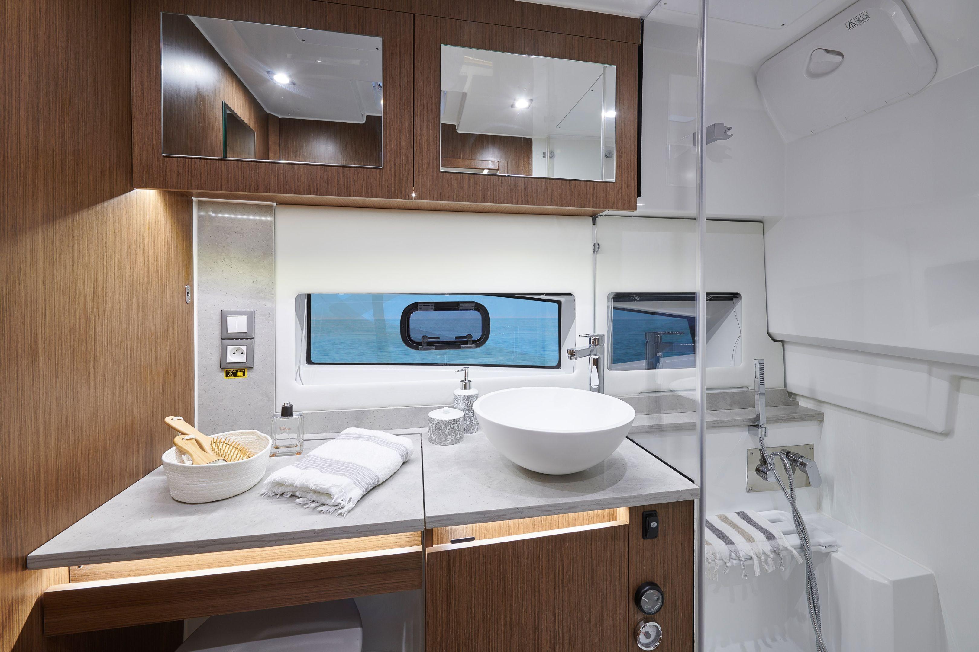 Luxurious bathroom interior of 2026 Jeanneau Leader 12.5 WA yacht with modern fixtures.