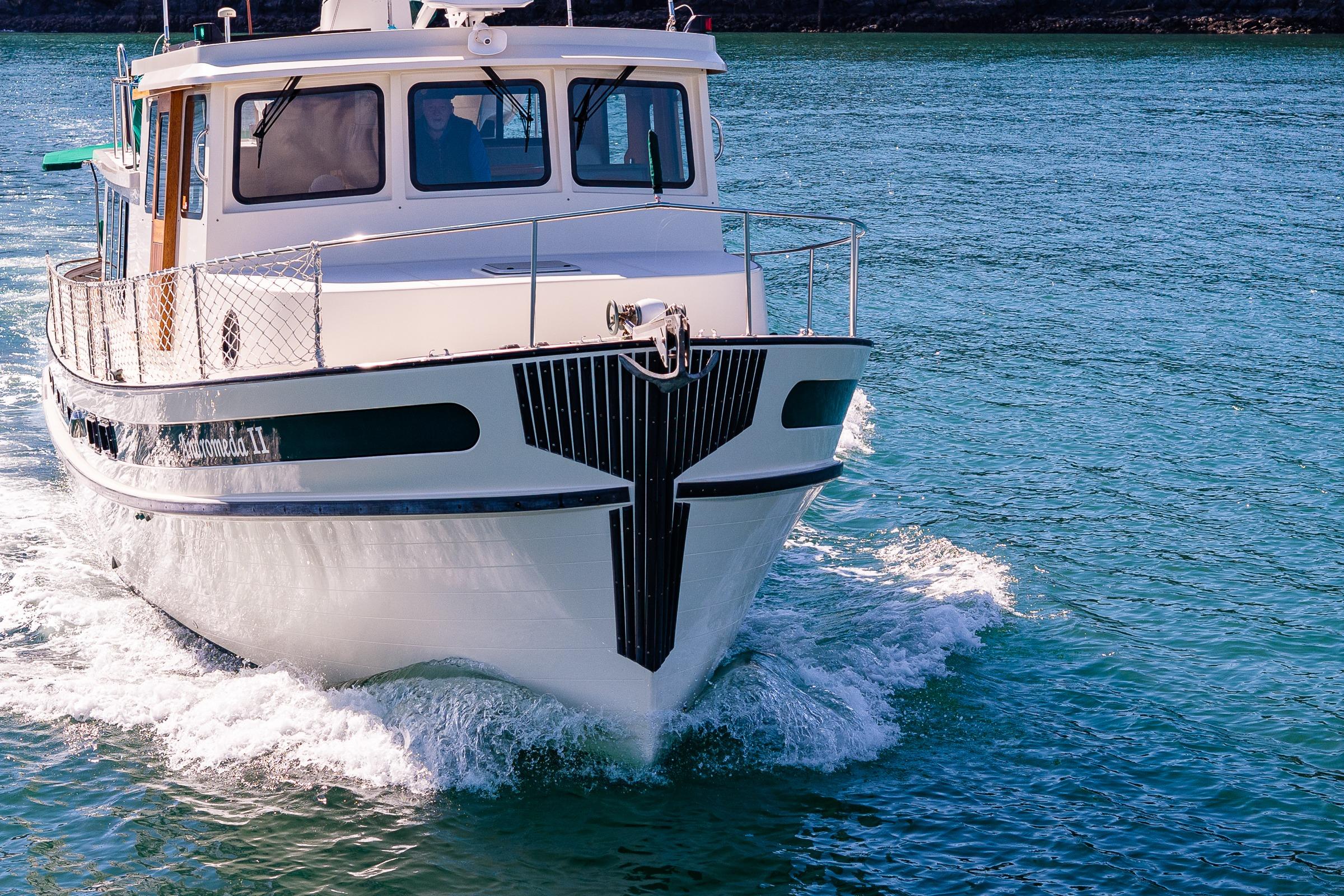 1997 Nordic Tug 42 cruising on clear blue water.