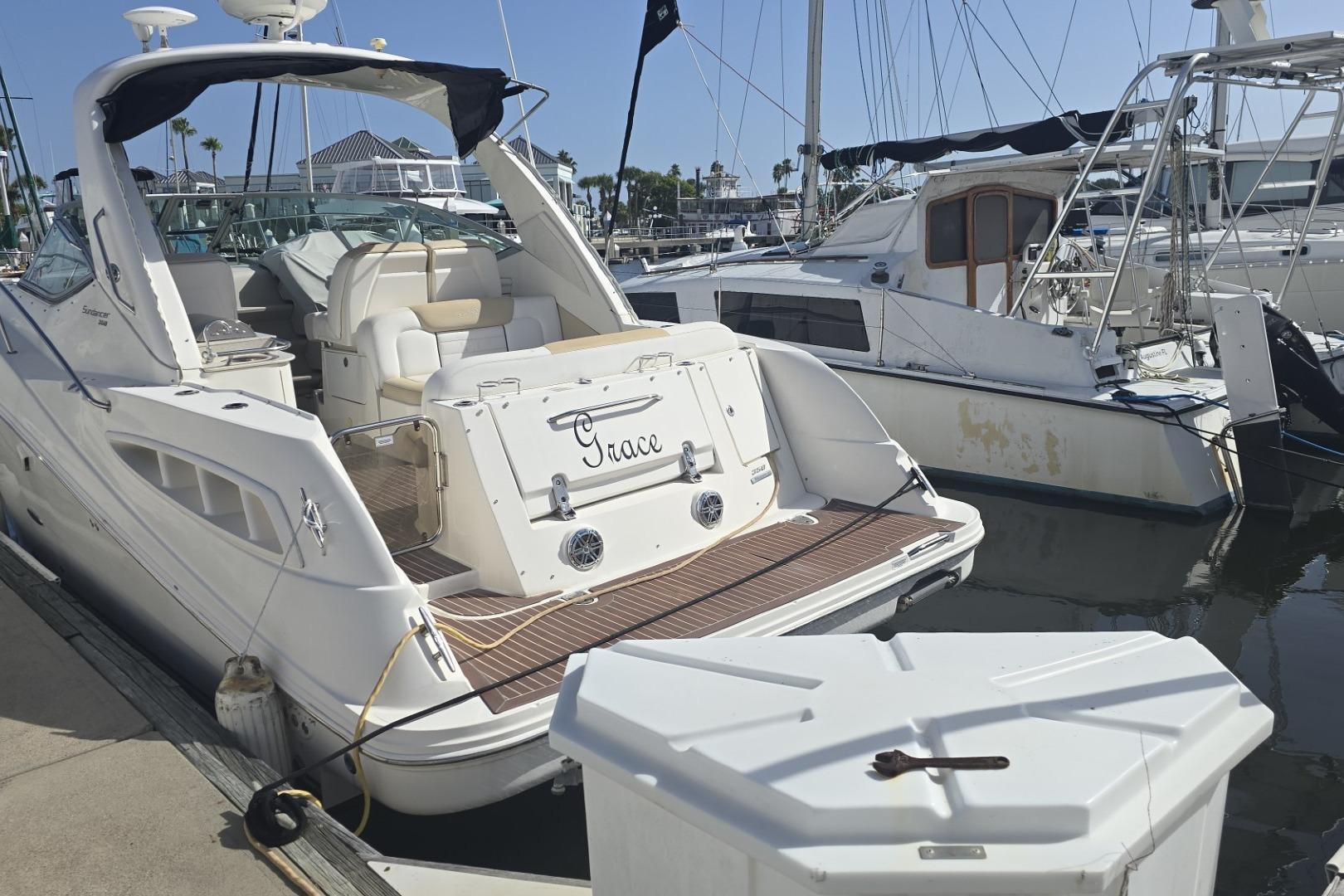 2010 Sea Ray 350 Sundancer yacht docked at marina, featuring spacious deck and elegant design.