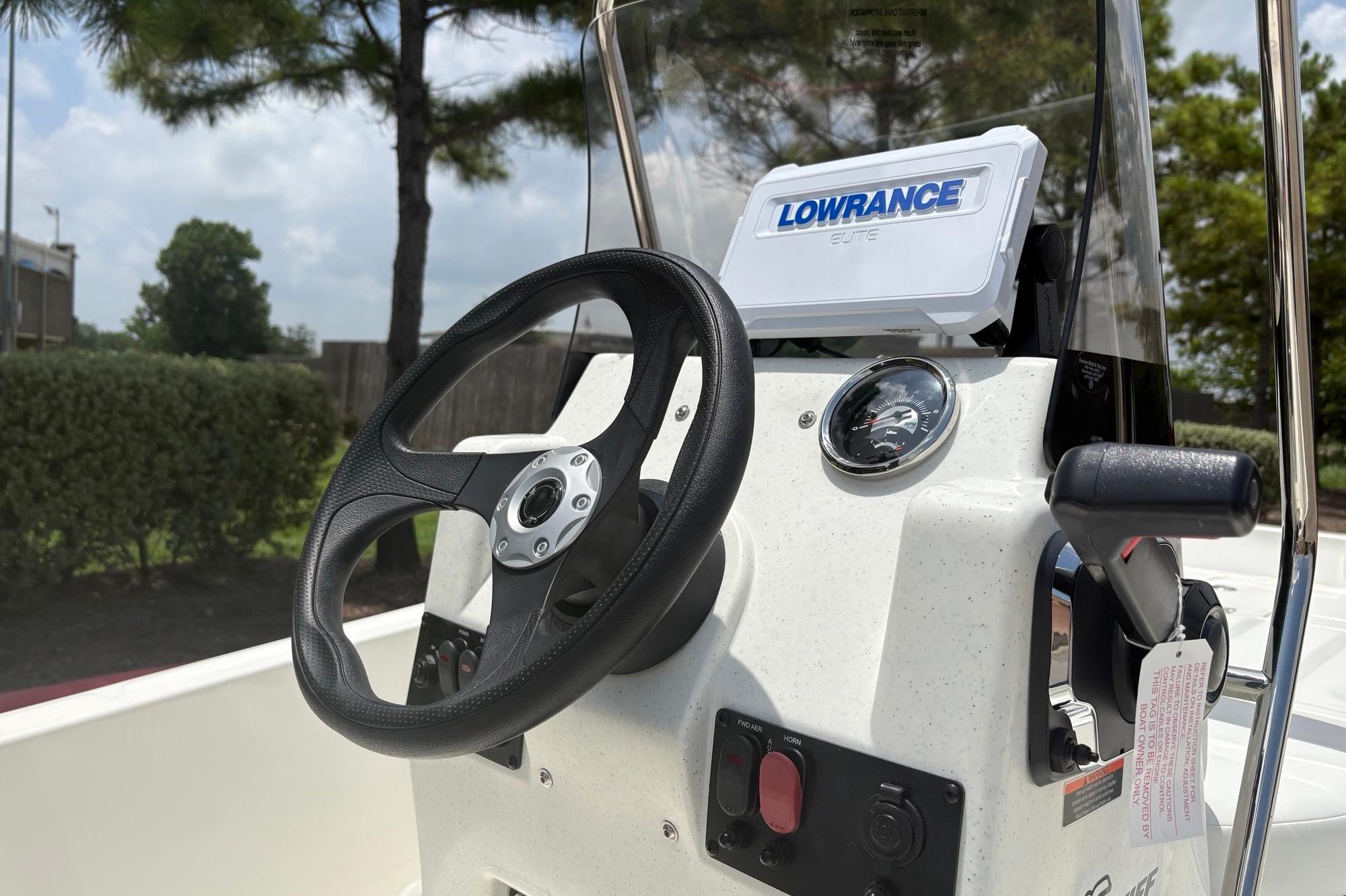 2026 Mako Pro Skiff 15 CC console with steering wheel and Lowrance Elite display.