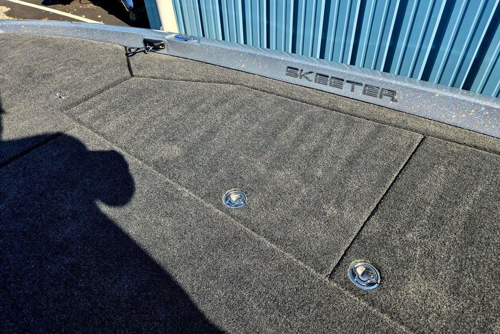 2026 Skeeter ZXE20 boat deck with carpeted surface and storage compartments.