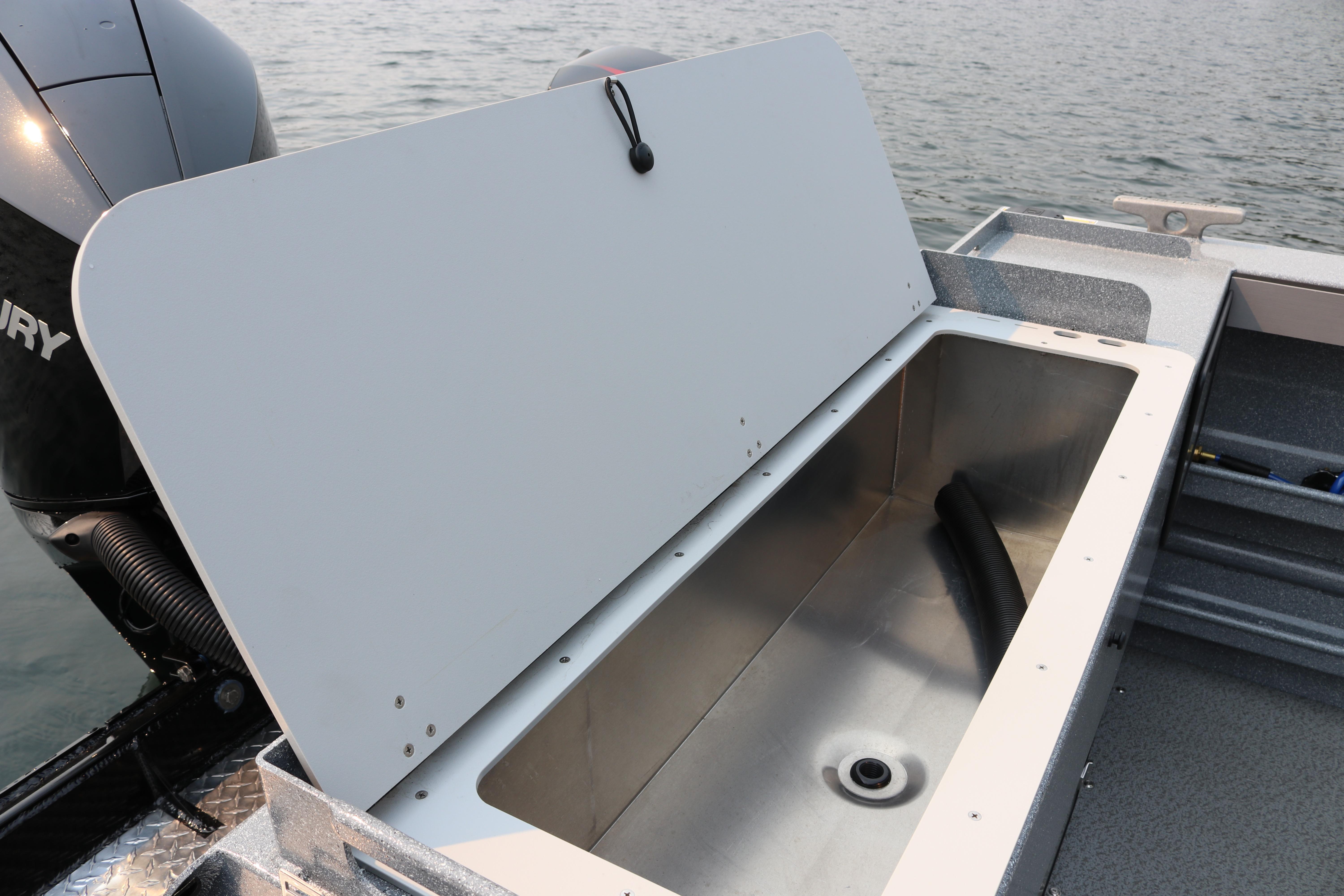 Open storage compartment on 2026 KingFisher 2425 Escape HT boat, near water.