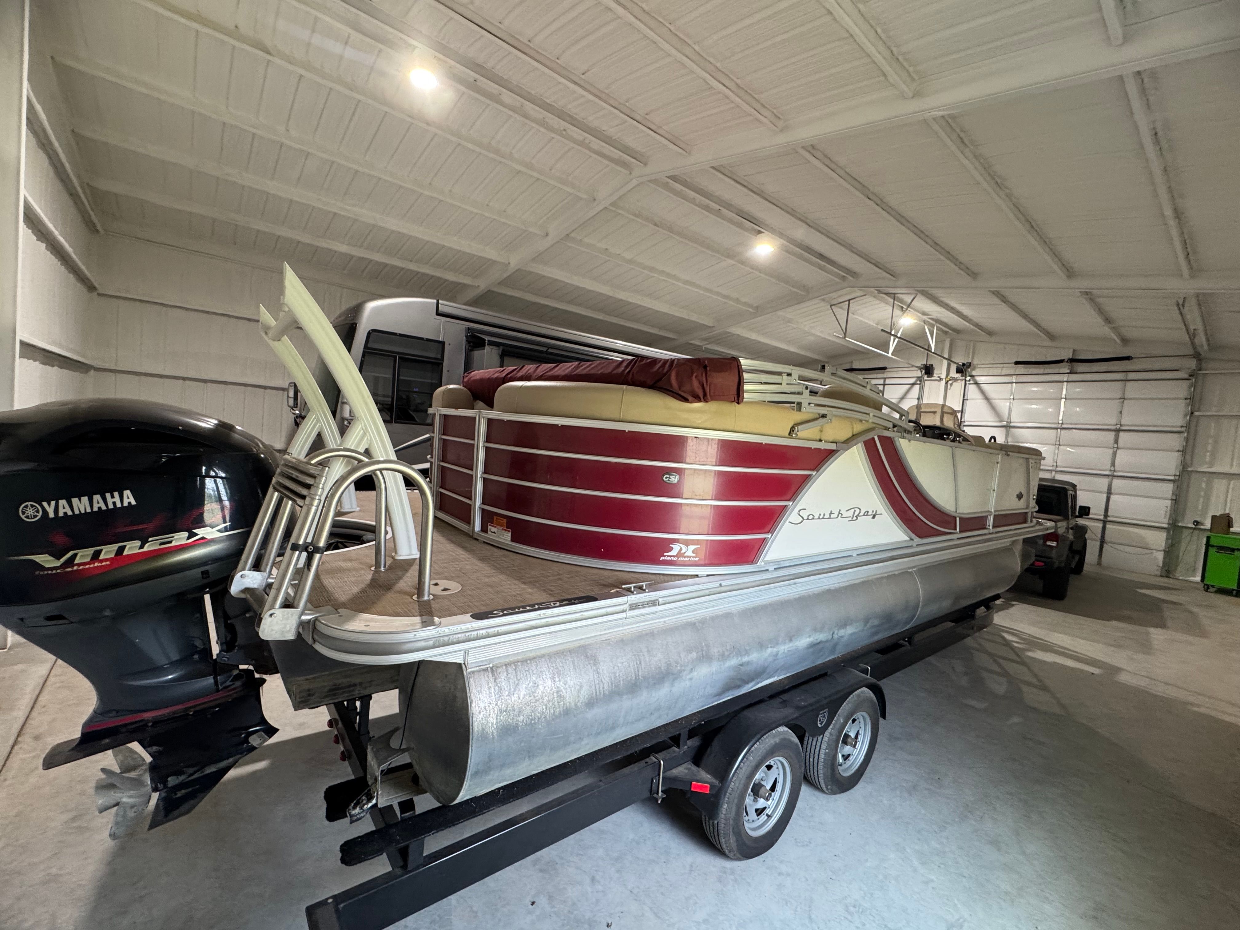 2016 Custom 523 RS pontoon boat in storage with Yamaha motor.