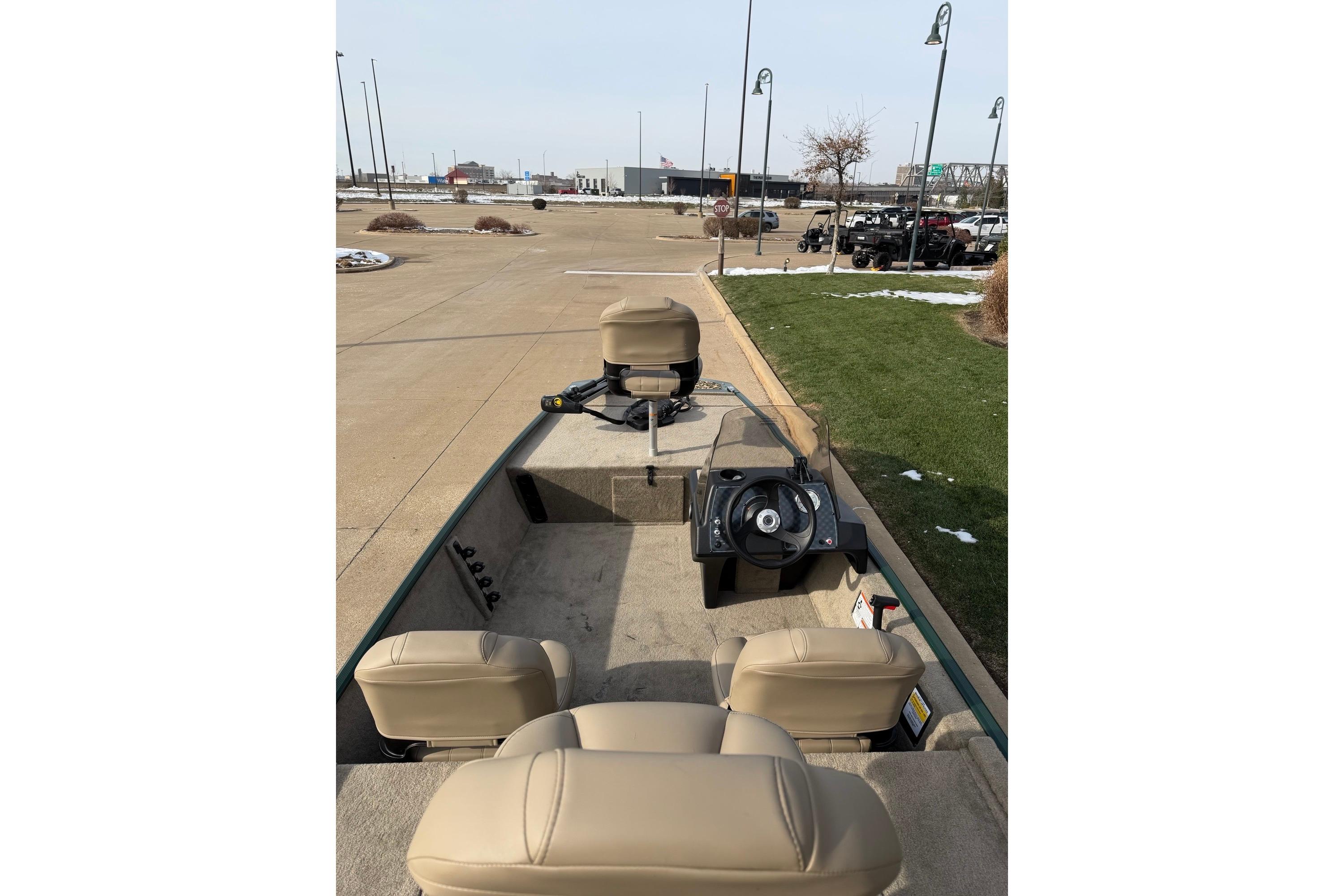 2026 Tracker Bass Tracker Classic Limited boat interior with beige seats and steering wheel.