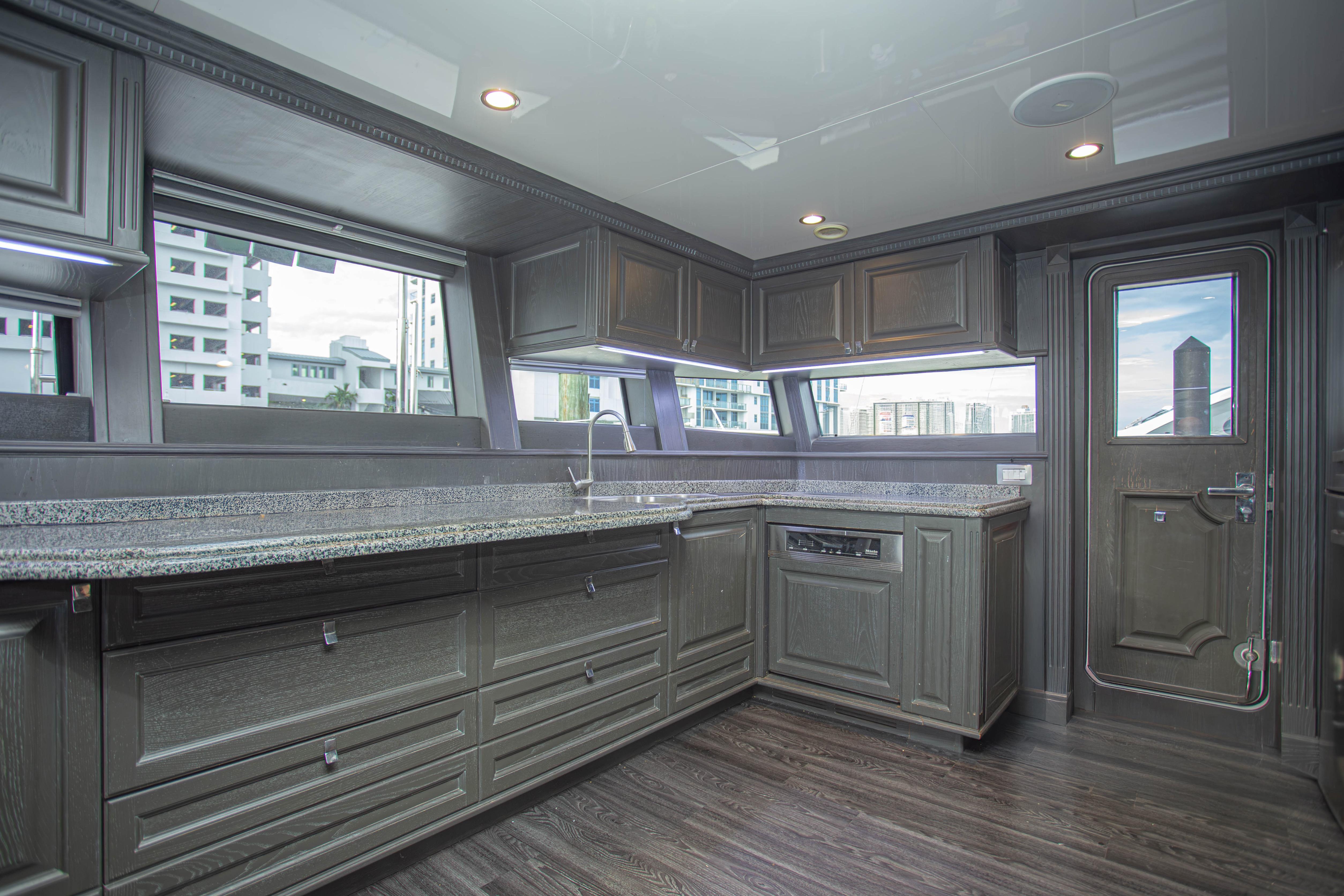 Luxurious kitchen interior of 2014 Fifth Ocean Yachts 24m Explorer Yacht with sleek cabinetry.