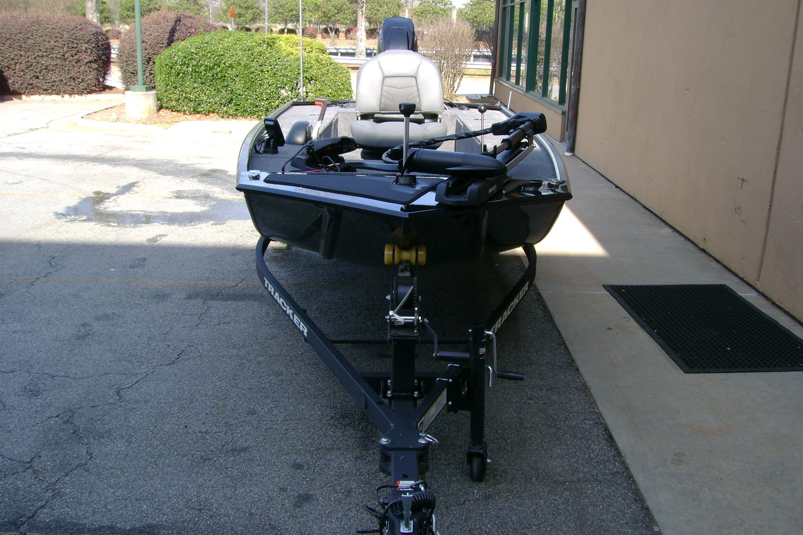 2026 Tracker Panfish 17 boat on trailer, parked outdoors near a building.
