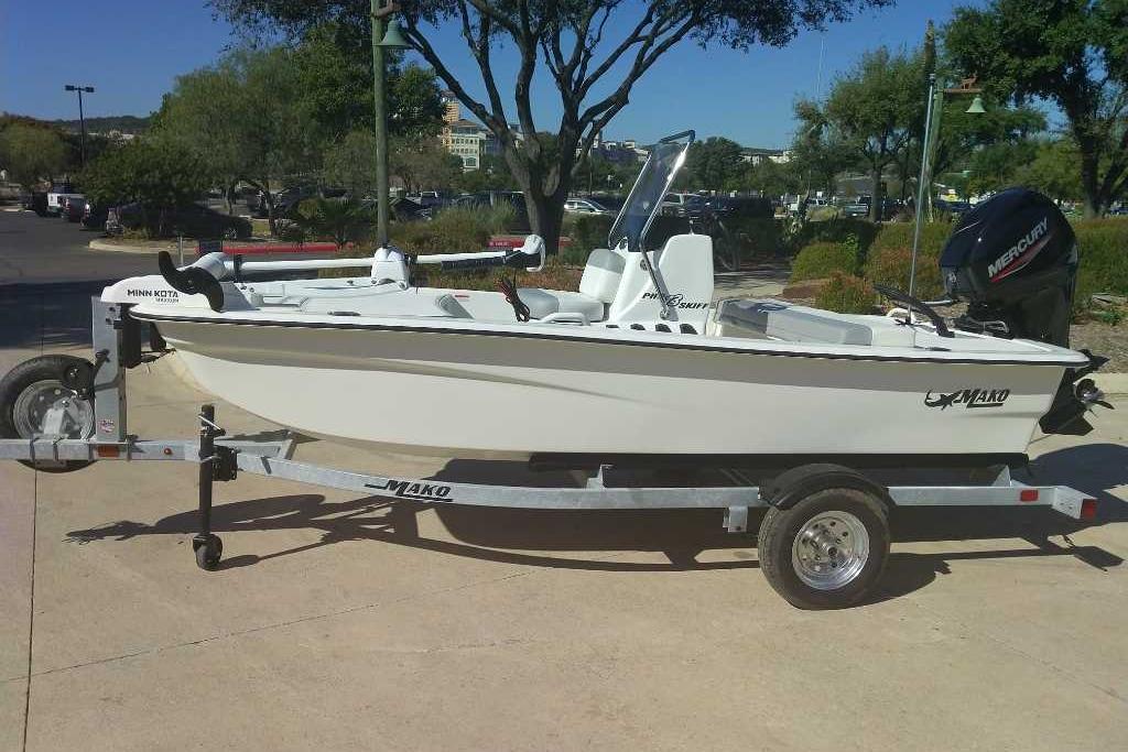 2026 Mako Pro Skiff 13 CC boat on trailer, parked outdoors.