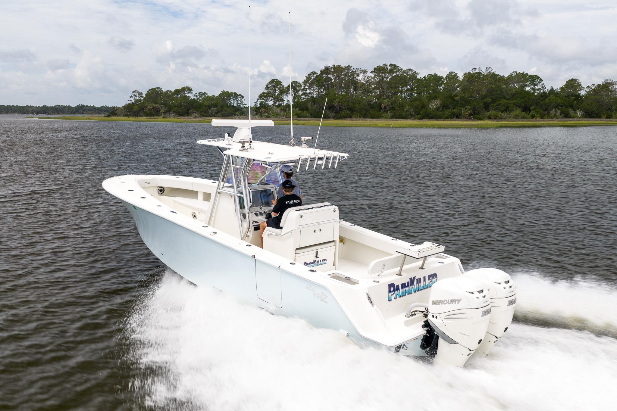 2019 SeaVee 322Z boat cruising on water with twin Mercury engines, scenic background.