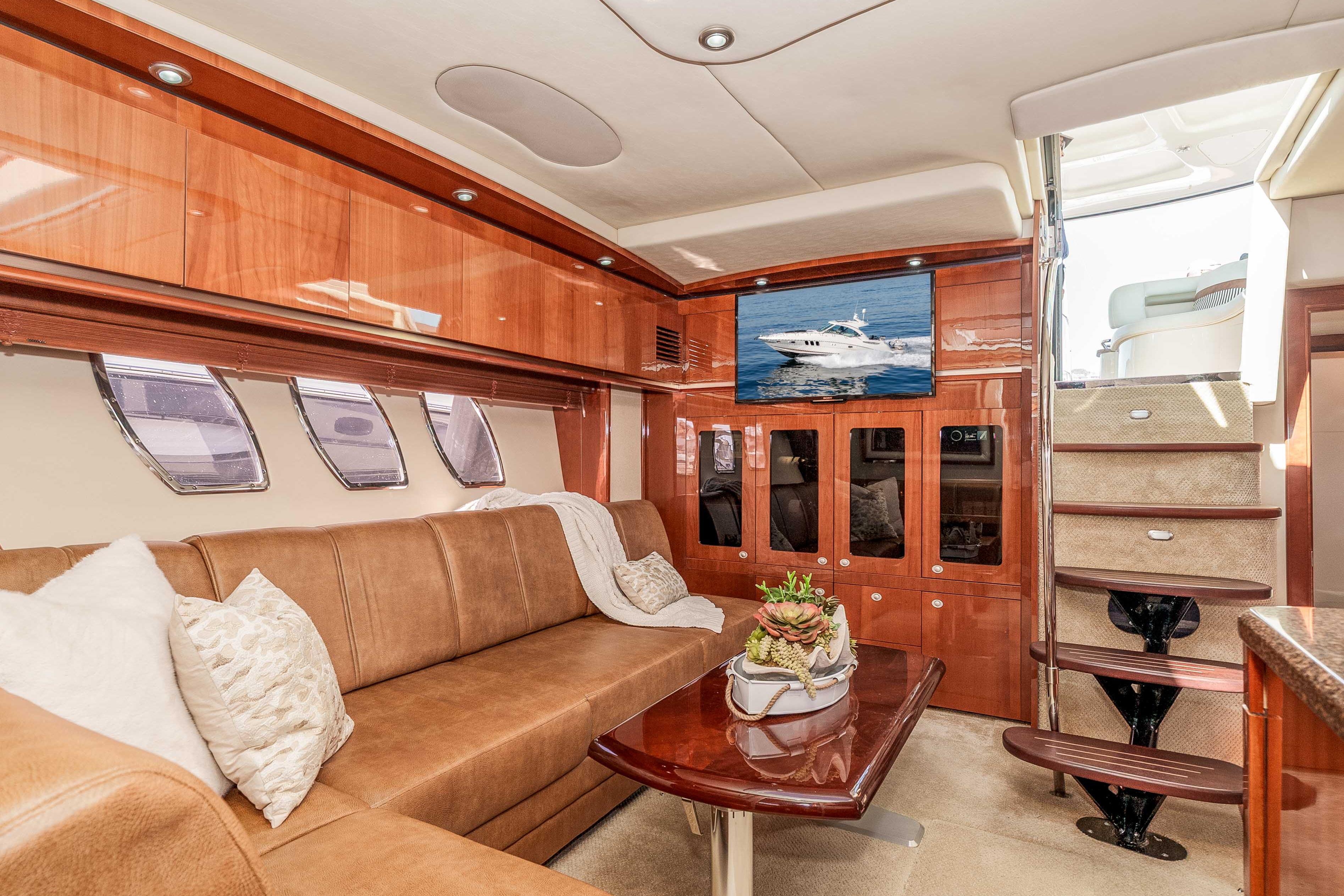 Luxurious interior of 2007 Sea Ray 48 Sundancer yacht with plush seating and elegant wood finishes.