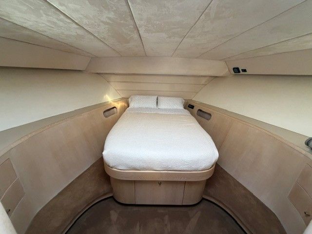 Interior of a 1990 Custom MOTOR YACHT with cozy bed.