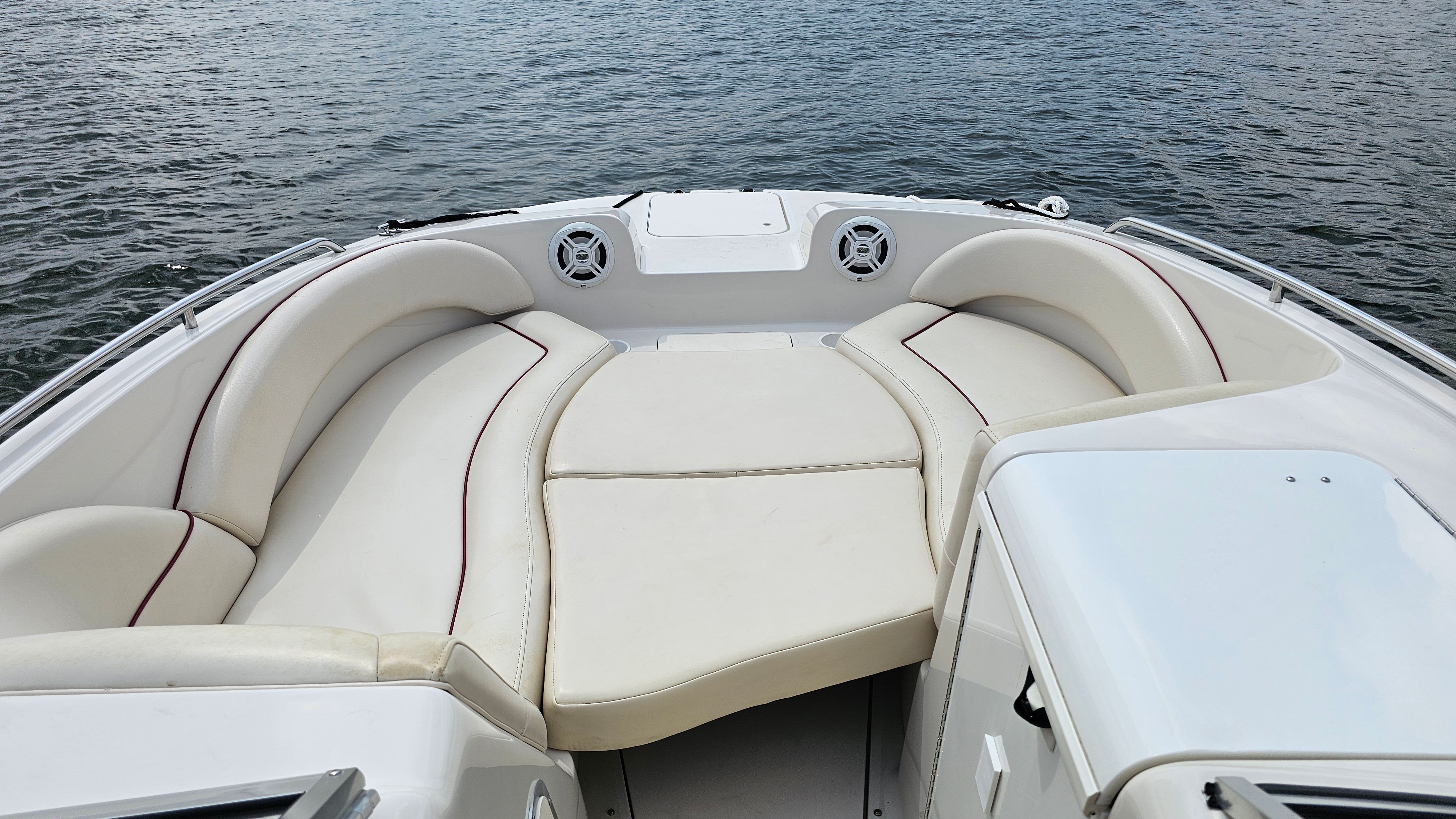 The image shows the bow of a 2002 Monterey 220 Explorer Sport boat with beige seating.