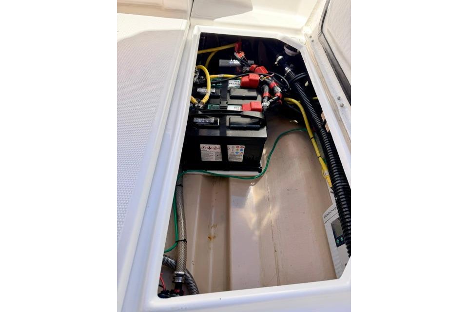 2017 Cutwater C-242 Coupe battery compartment with wiring and connections.