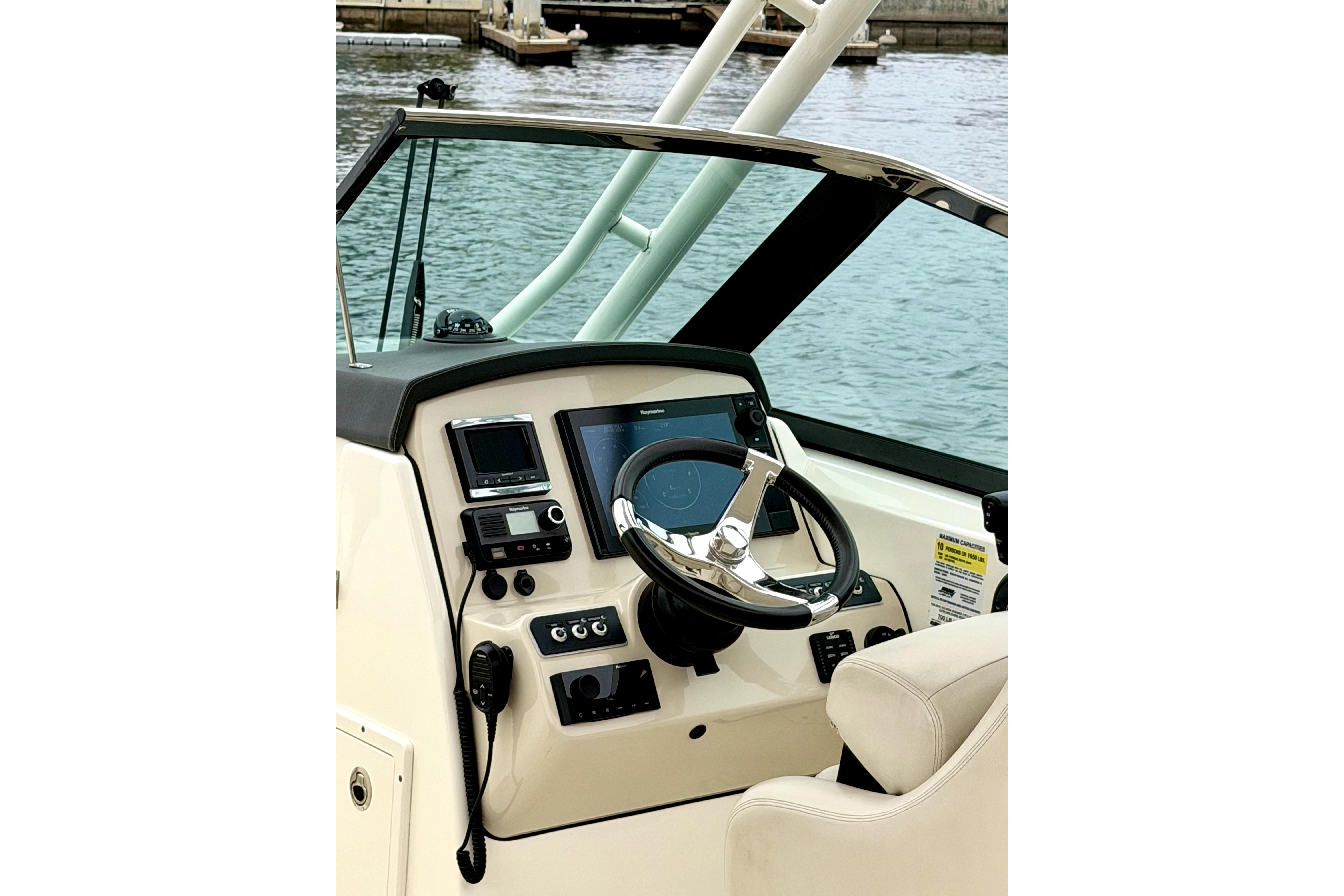 2017 Boston Whaler 230 Vantage boat helm with steering wheel and navigation controls.