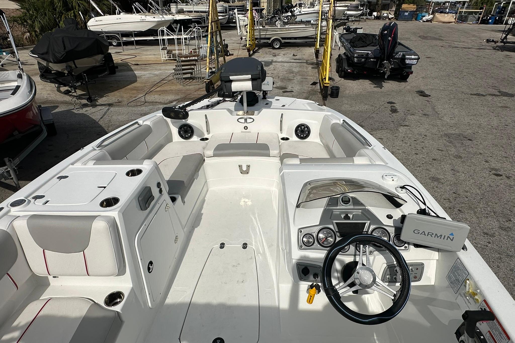 2021 Tahoe 2150 boat interior with Garmin navigation, spacious seating, and modern dashboard.
